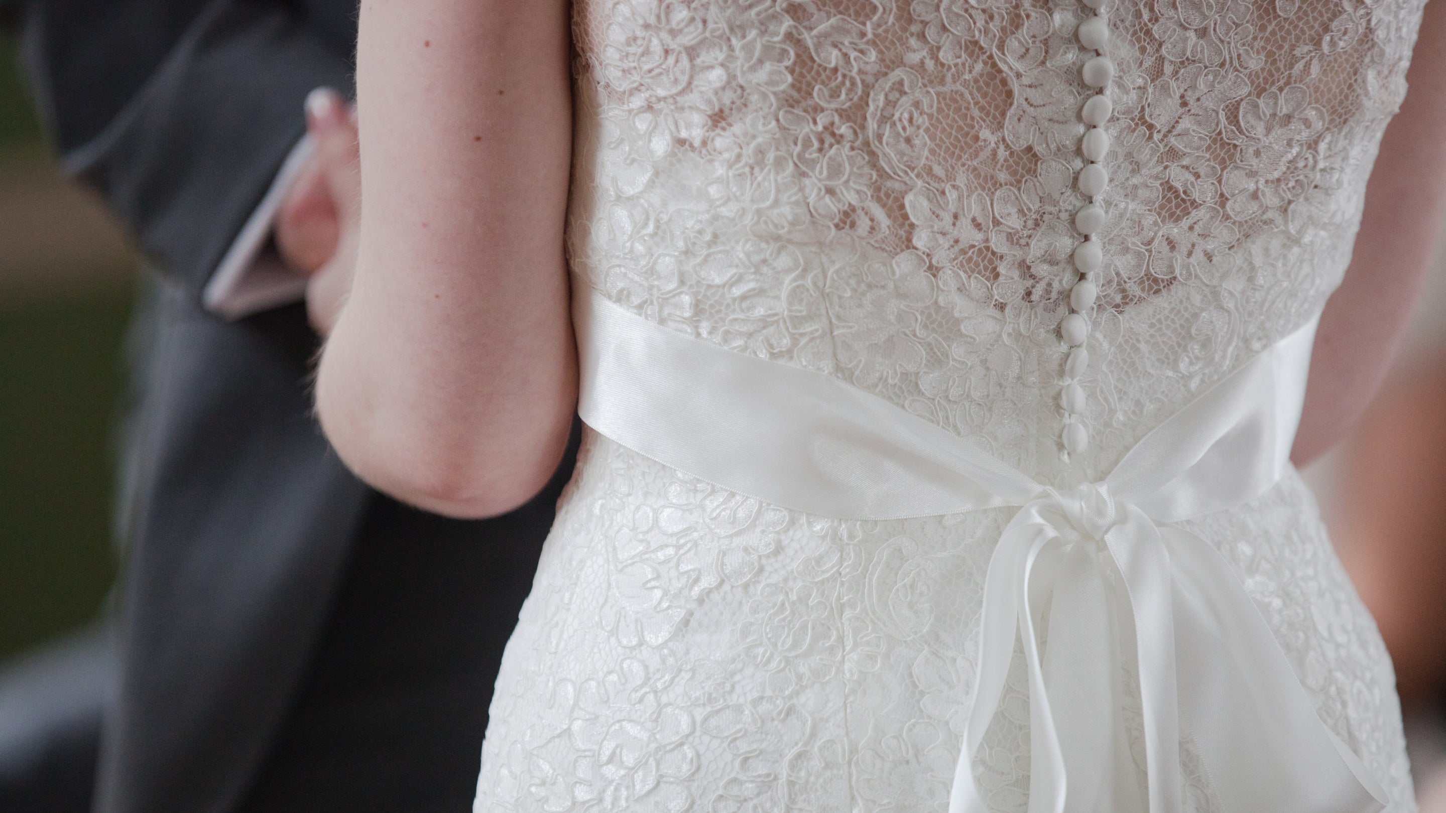 Detail of the back of the bride's dress from a wedding at Mount Stewart House and Garden, County Down, Northern Ireland.