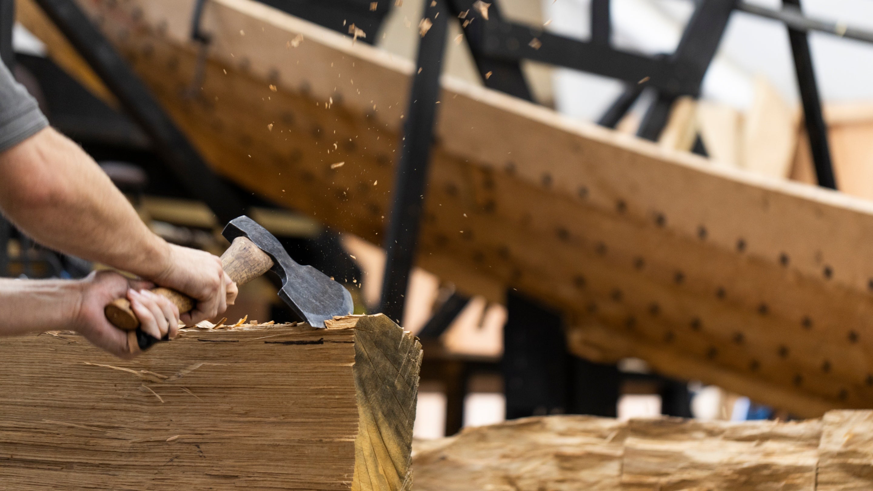 Apprentice joiner using traditional method to build a replica of the Sutton Hoo royal burial ship in Suffolk