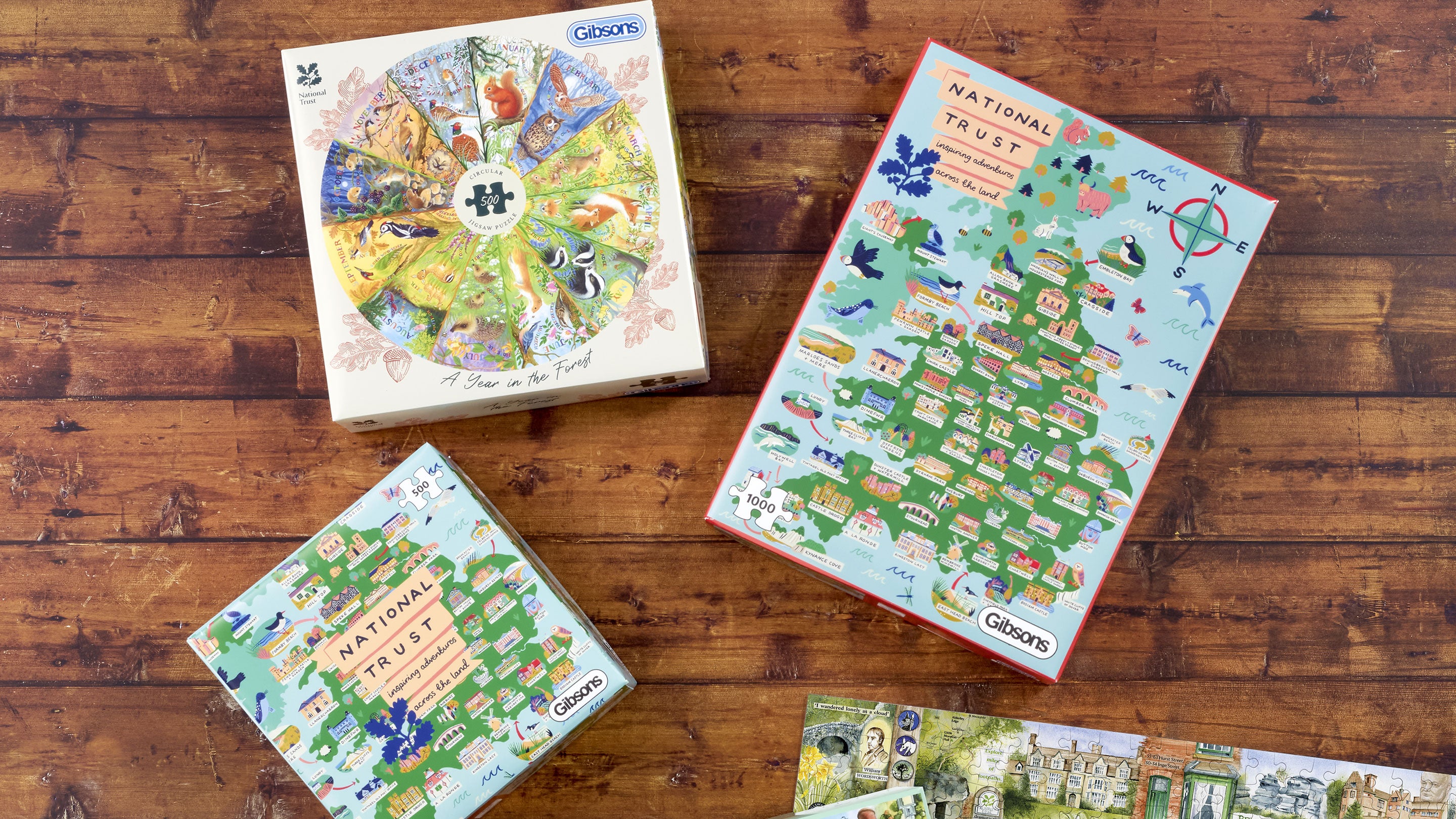 Three puzzle boxes sit on a wooden floor