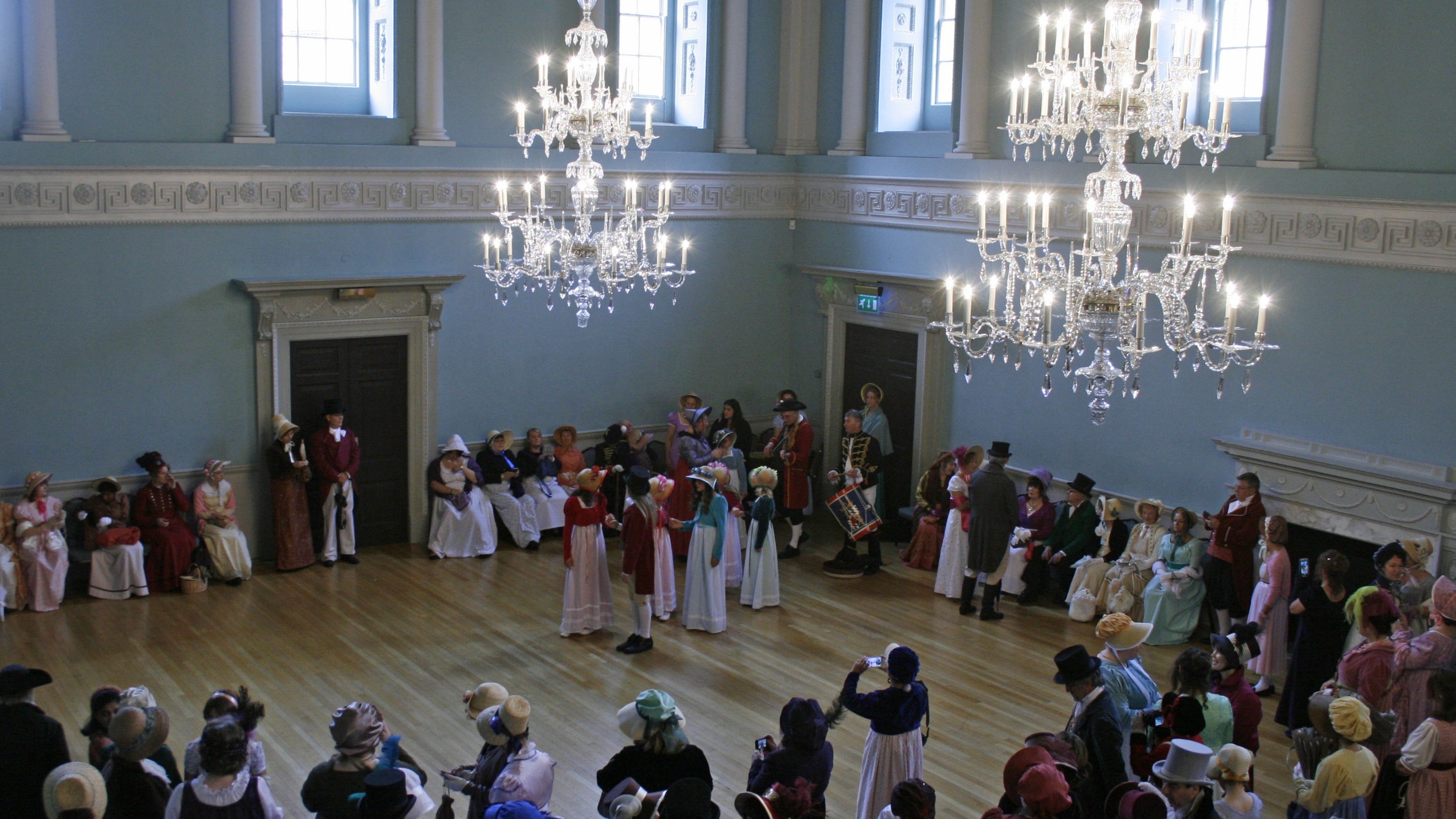 Visitors in period costume dance in the Ball Room at the Jane Austen festival at Bath Assembly Rooms, Bath