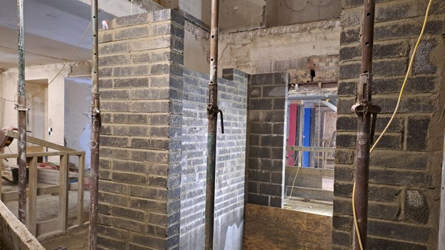 Brick work can be seen coming out of the lift pit in the lower ground floor, it doesn't quite reach the ceiling on that floor yet.