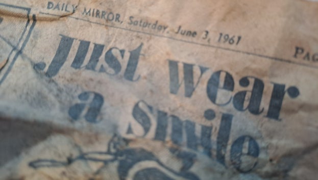 Close-up of a crumbled newspaper that reads: Daily Mirror, Saturday, June 3, 1961