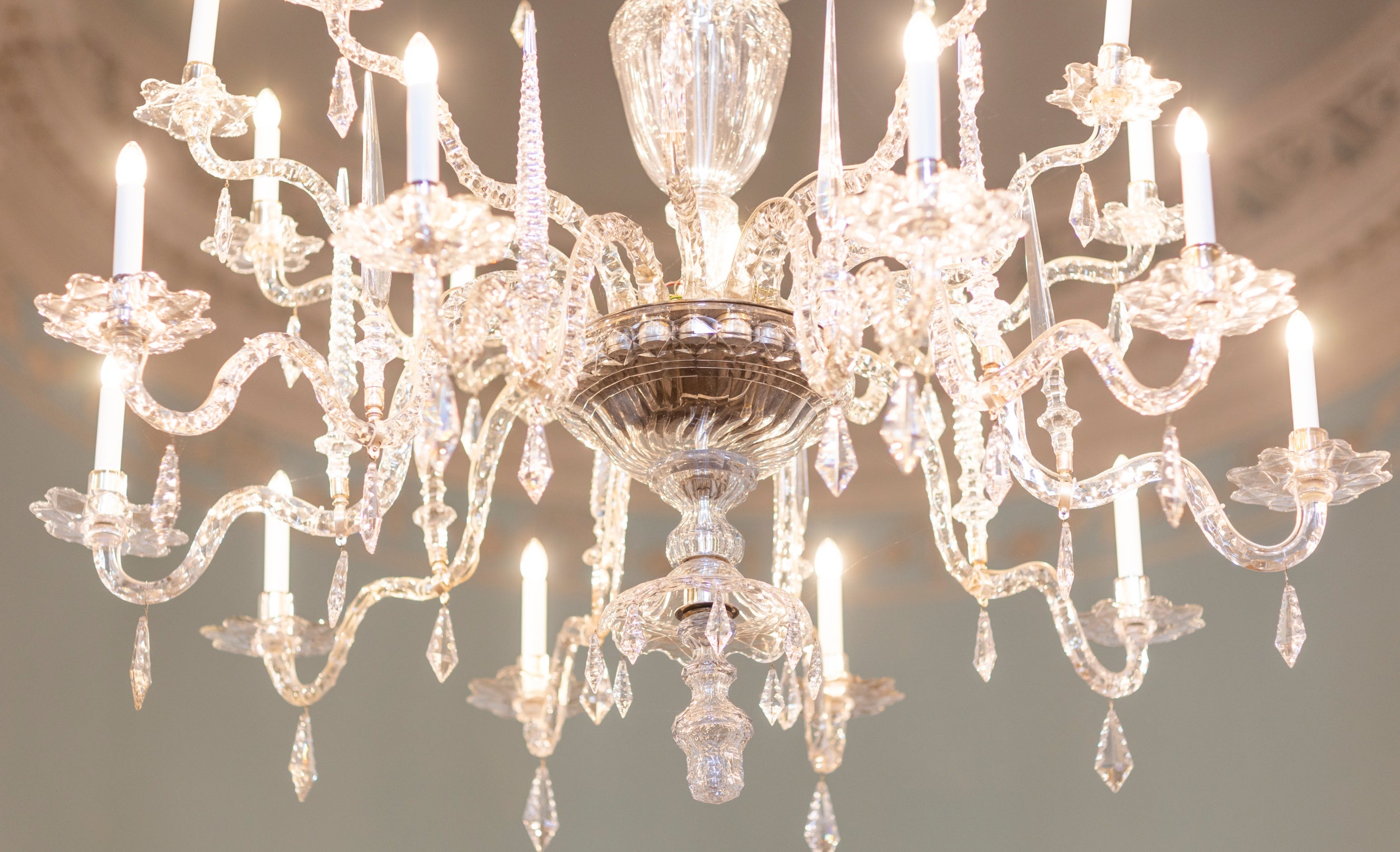 A close-up of one of the chandeliers in Bath Assembly Rooms with the lights on.