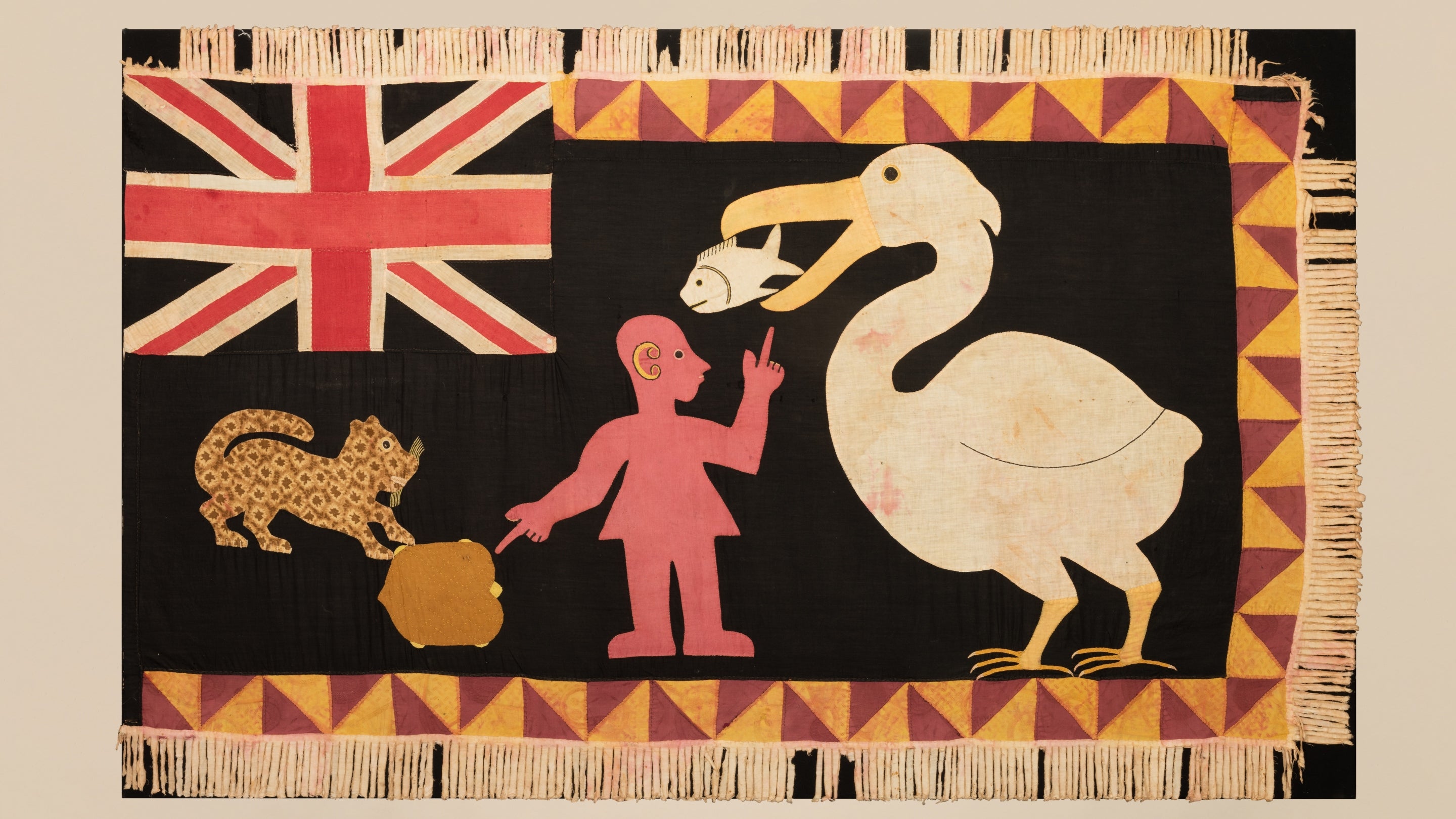 Brightly coloured Asafo flag from Ghana showing a pelican, a fish, a leopard, a human and a British flag