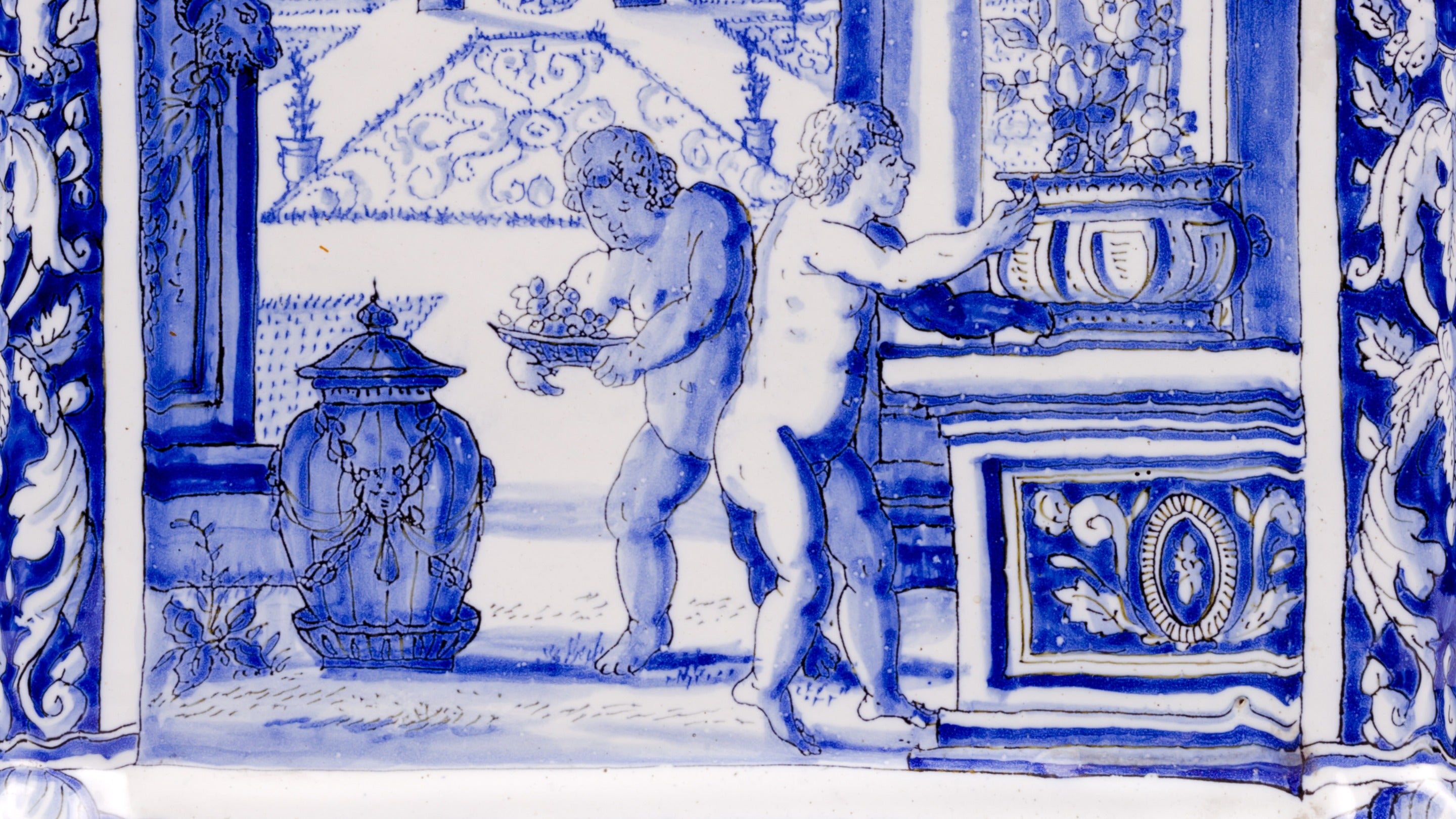 Detail from a Delftware flower pyramid at Dyrham Park in Bath. 'Amorini' (infant cupids) are arranging flowers in an urn, framed by classical architecture.