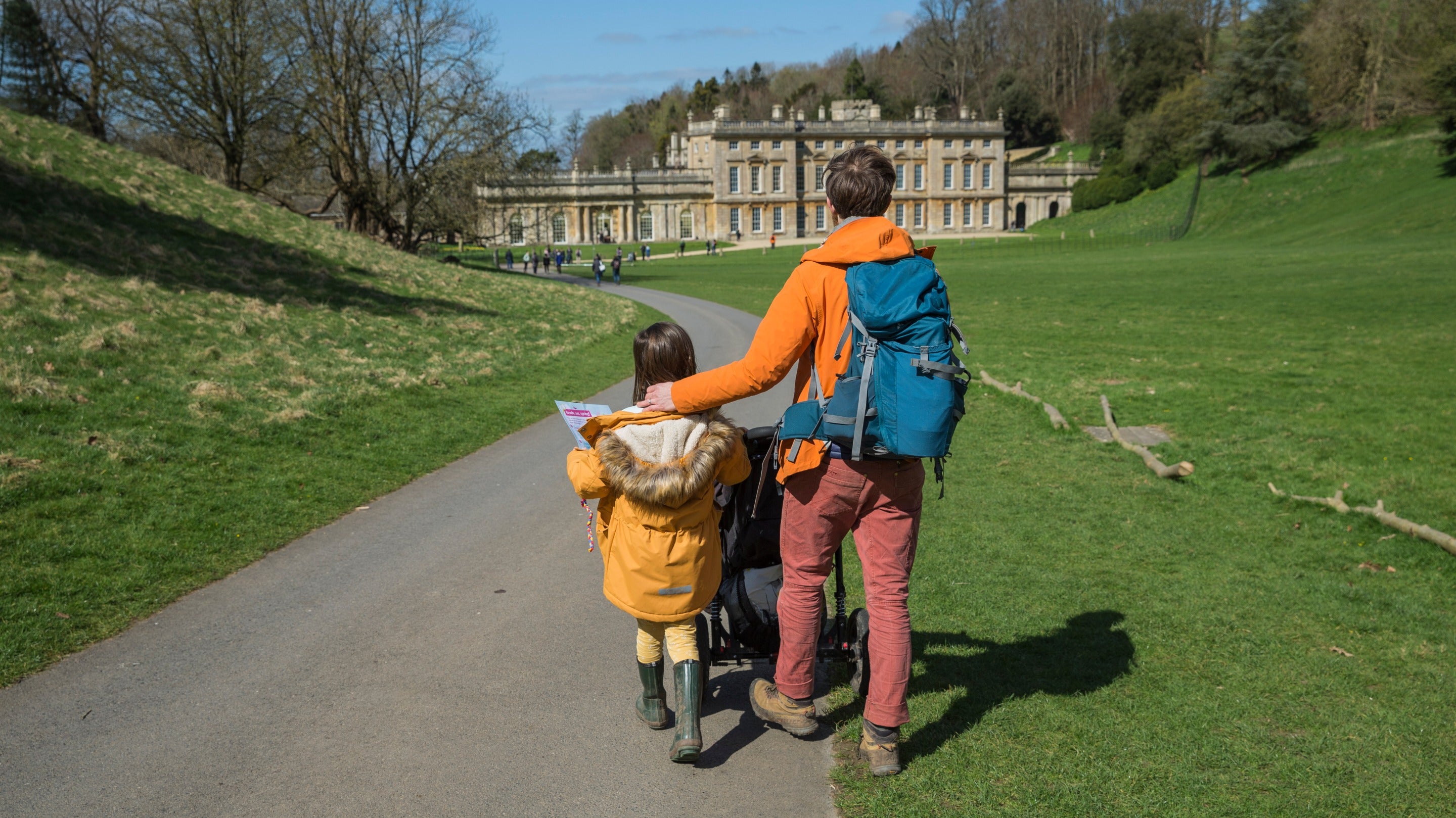 Family walking along a path towards Dyrham Park, Bristol and Bath