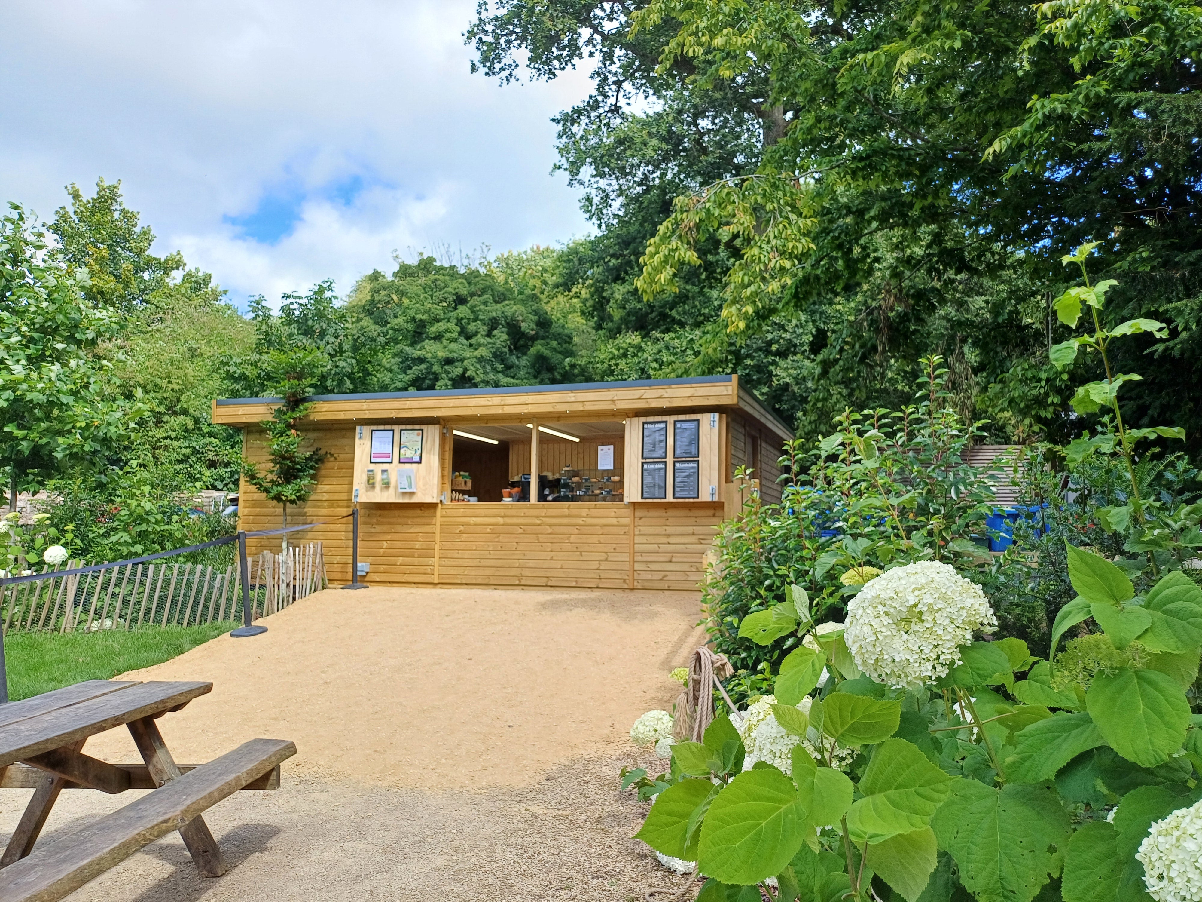 An outdoor cabin for refreshments surrounded by greenery