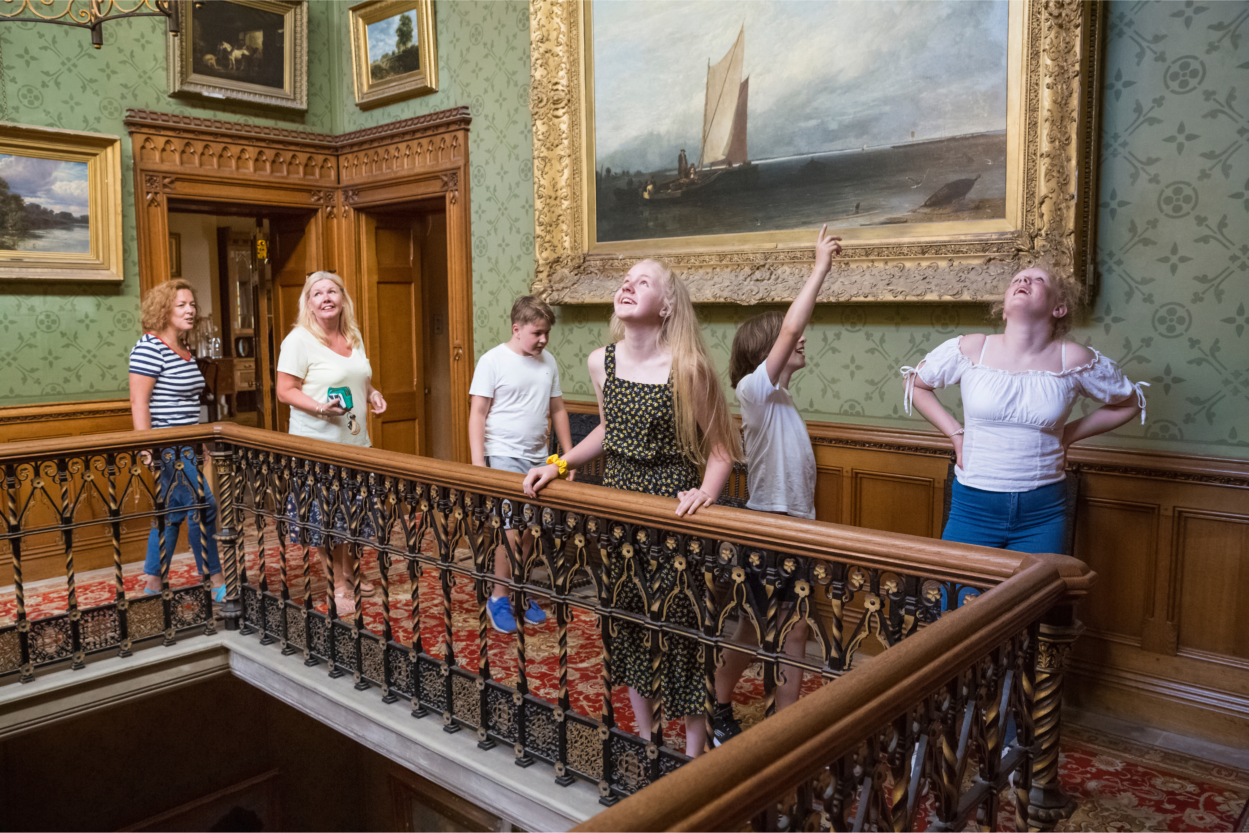 Family with teenage children exploring the house