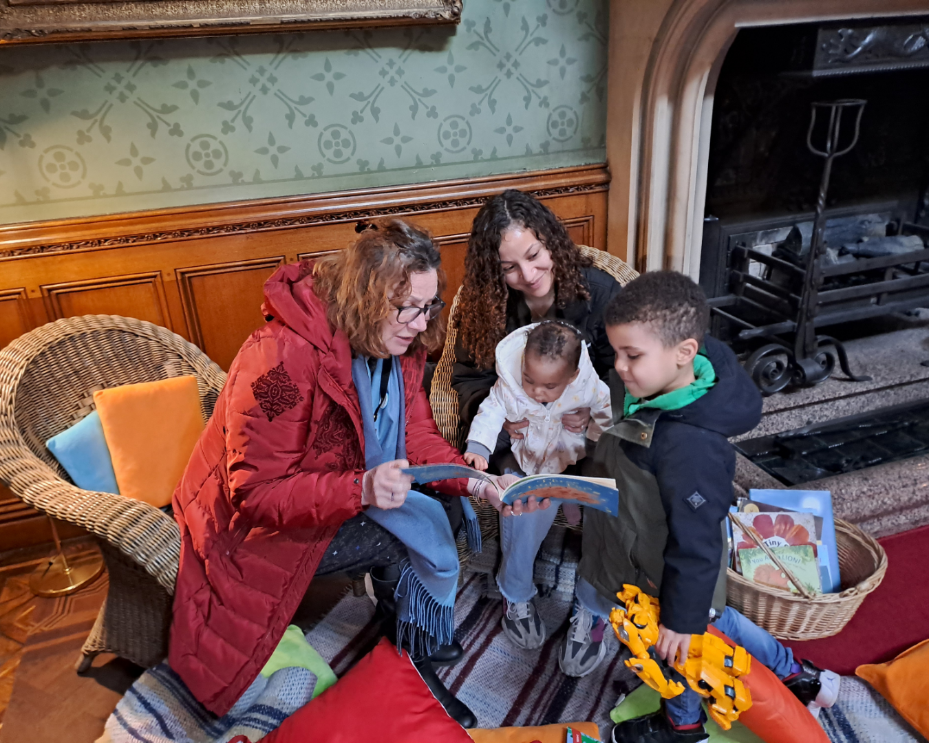 Volunteers read a book to a family