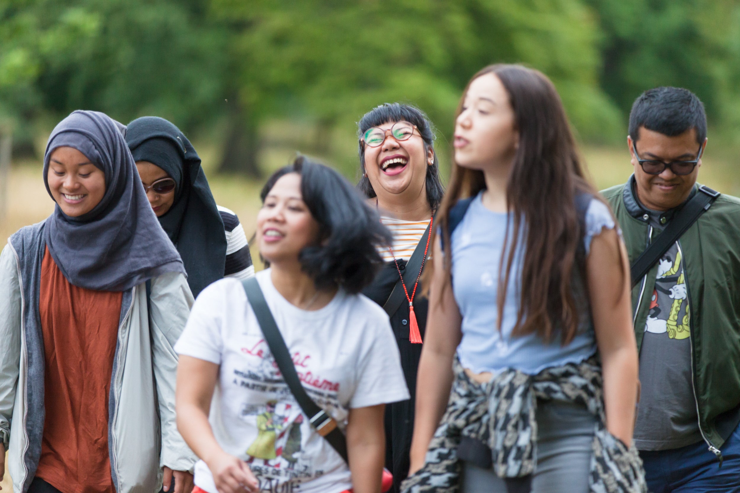 Visitors walking in the parkland at Lyme Park, Cheshire