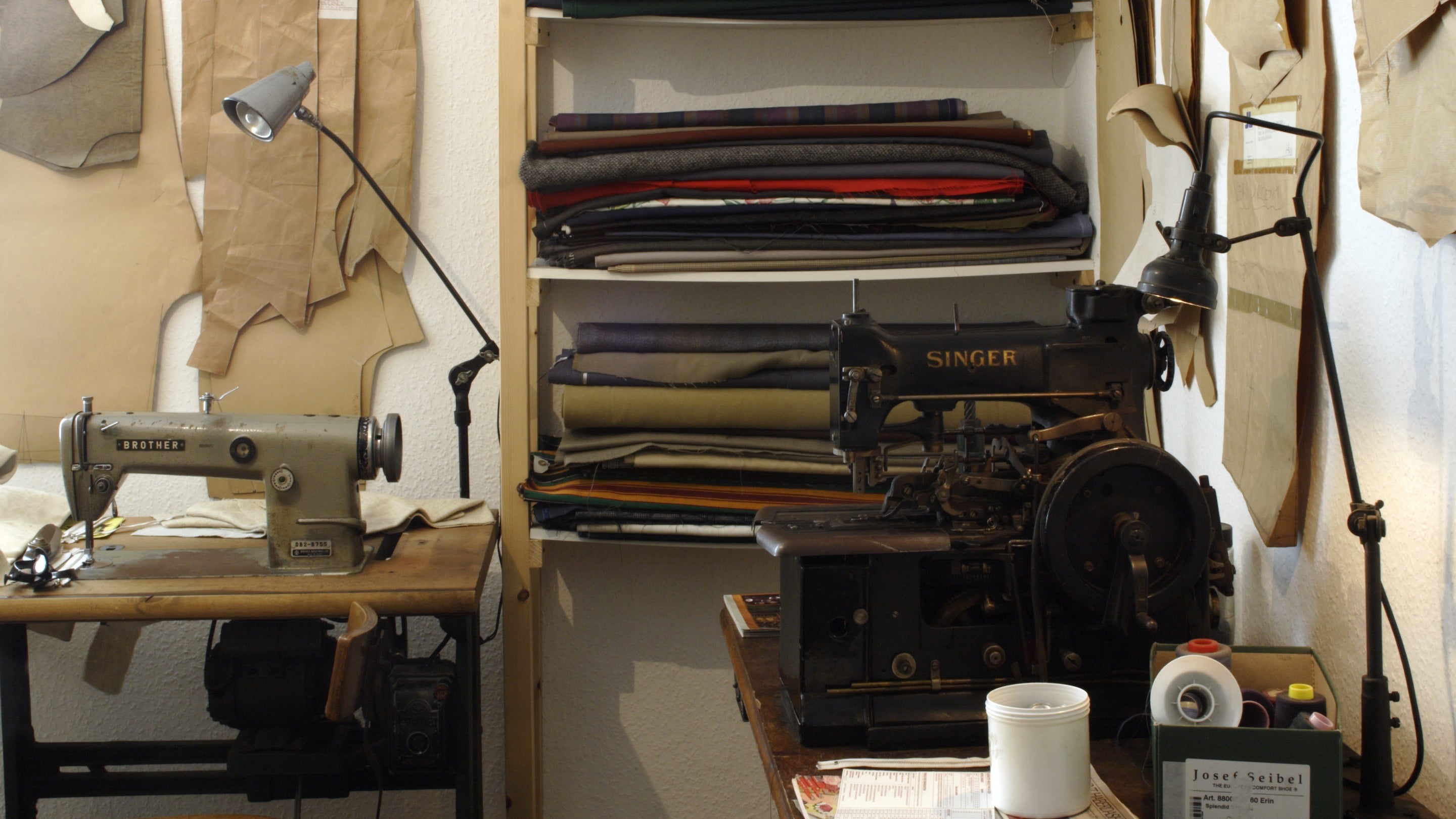 The workroom in the 1970s tailer's shop at the Birmingham Back to Backs, showing sewing machine, patterns and bolts of cloth.