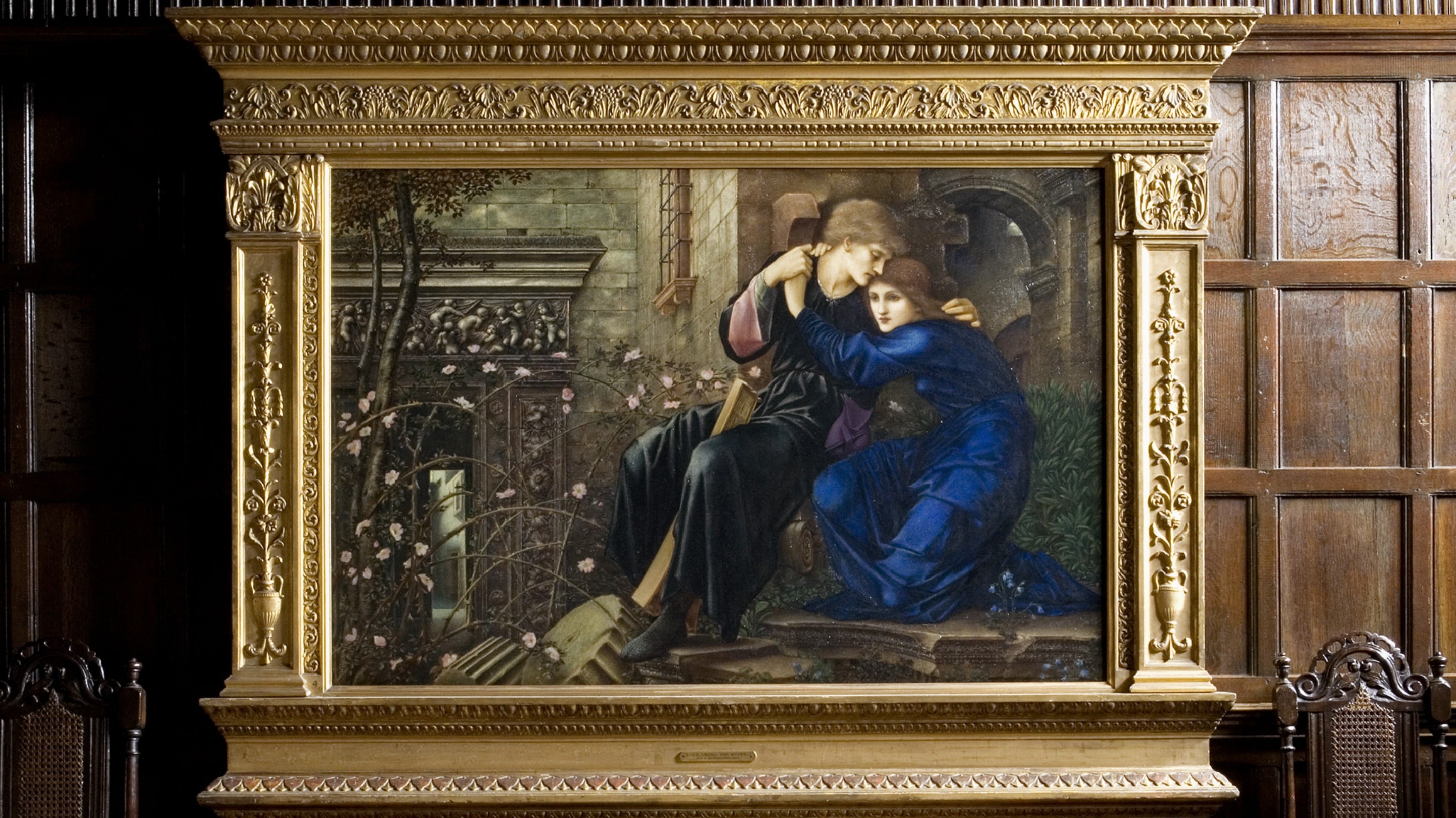 Oil painting, Love among the ruins, by Sir Edward Coley Burne-Jones (1833-1898), 1894, against the oak panelling of the Great Parlour at Wightwick Manor