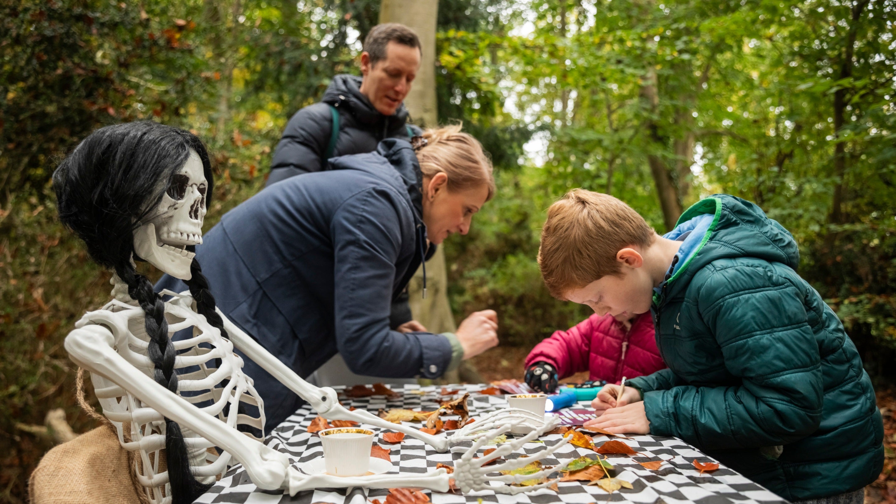 Visitors on the Halloween trail at Anglesey Abbey, Gardens and Lode Mill in Cambridgeshire