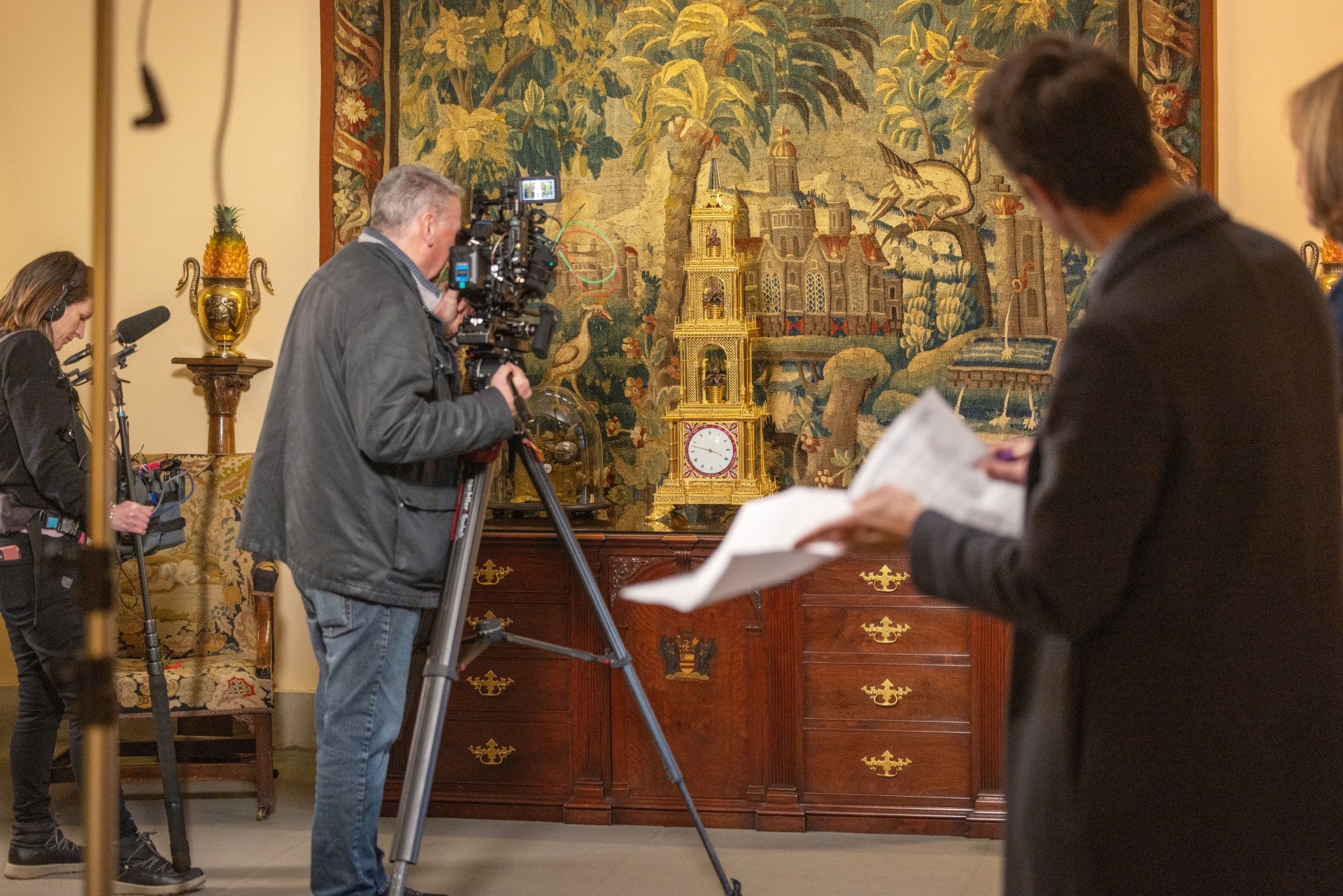 Camera crew filming the Pagoda Clock in the Living Room while the producer and Fiona Bruce look on.