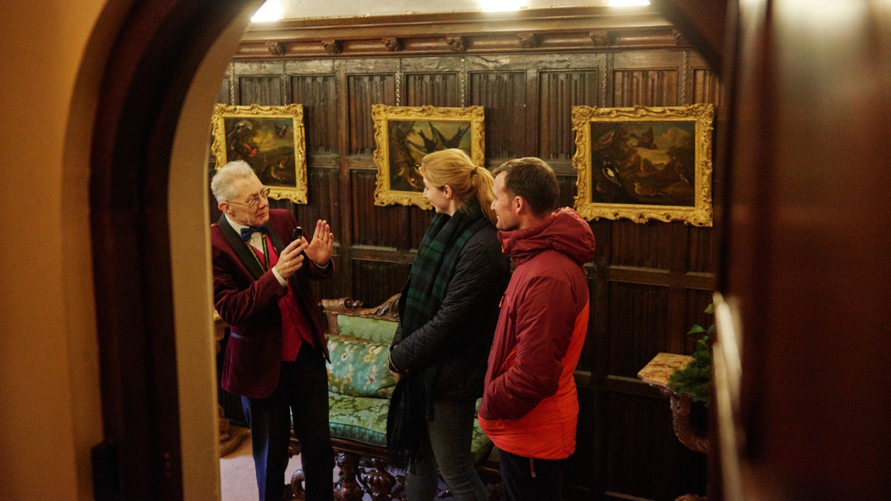 Volunteer talking with visitors at Anglesey Abbey, Cambridgeshire