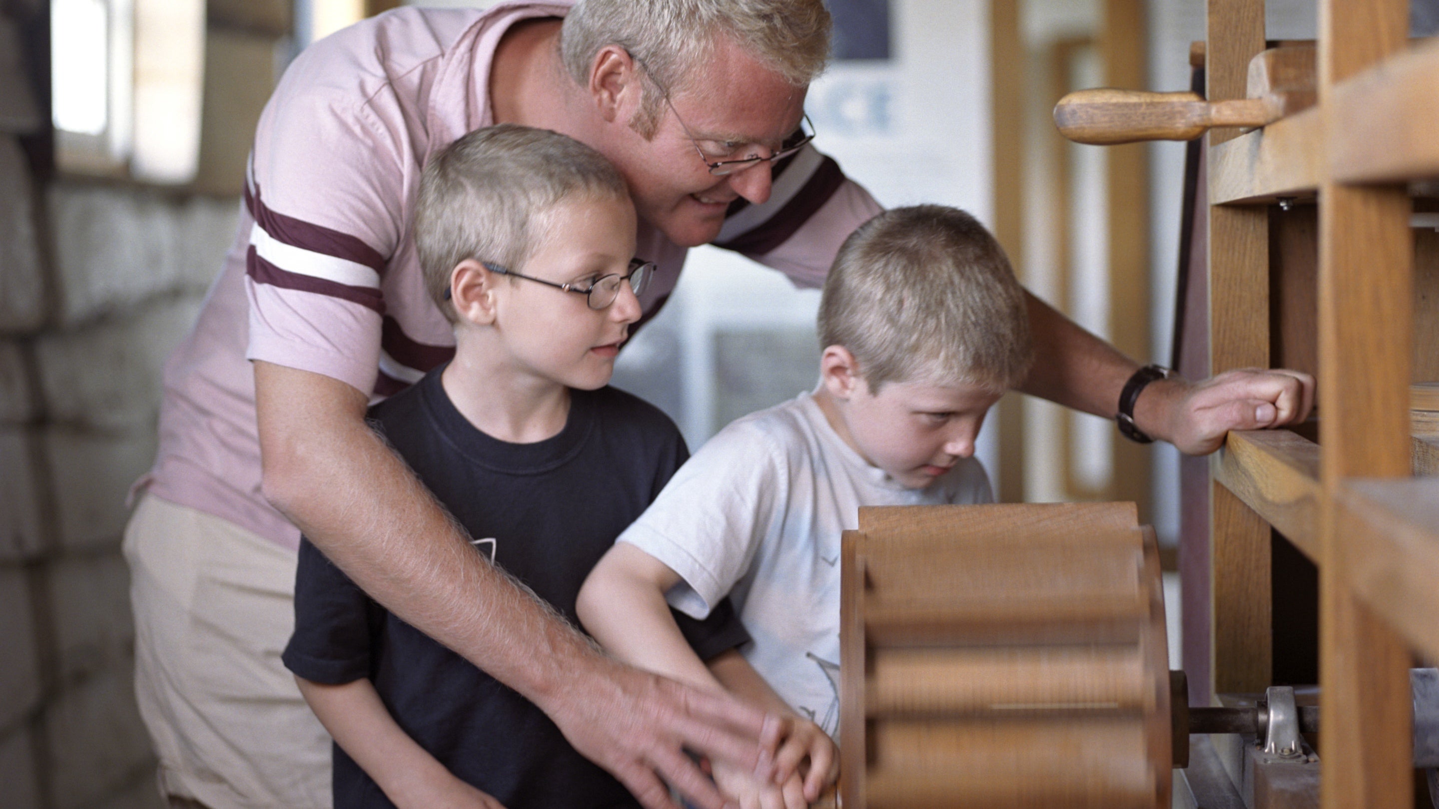 Visitors exploring an exhibit inside Houghton Mill, Cambridgeshire.