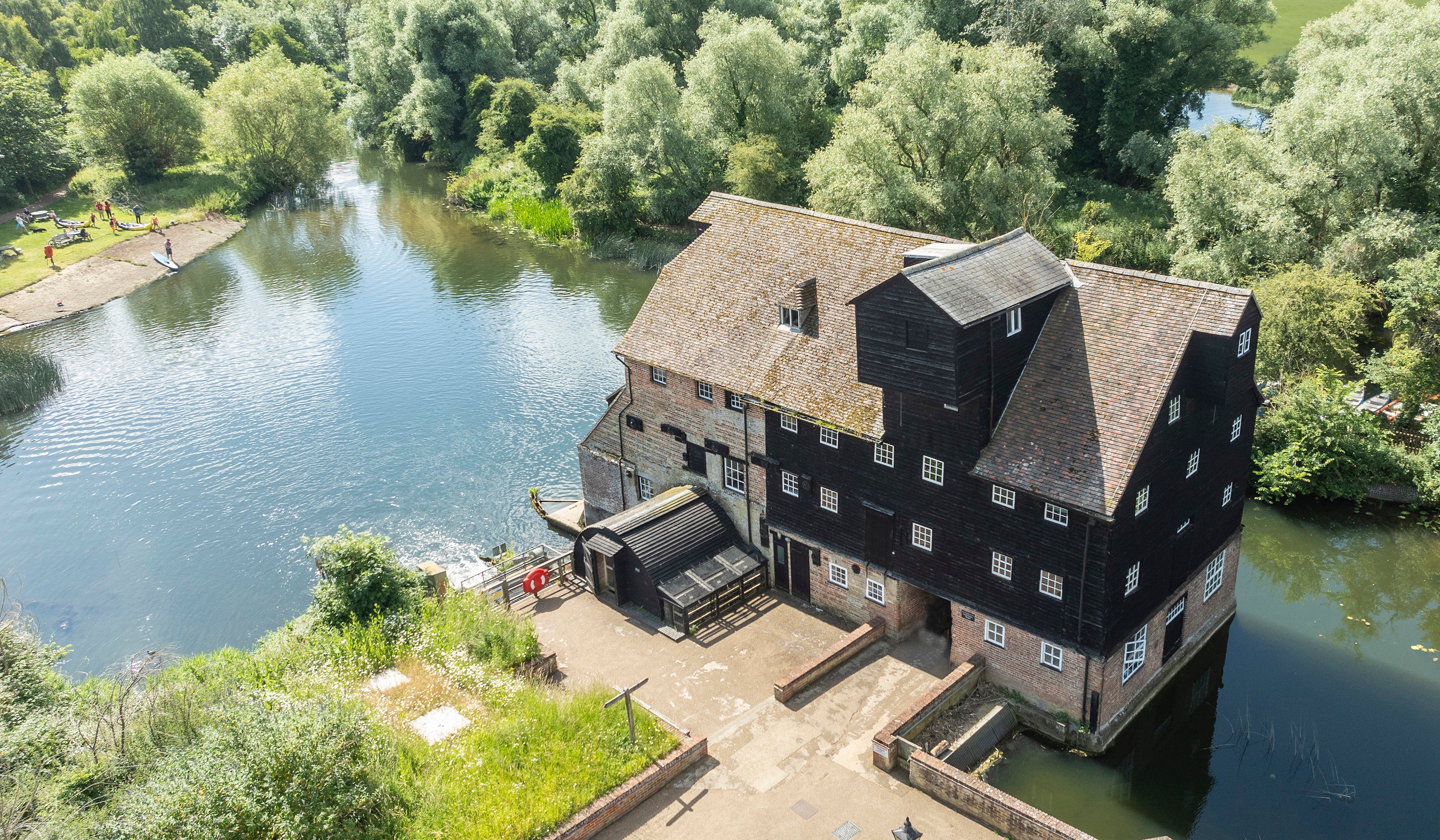 An aerial photo of Houghton Mill and the water taken in summer