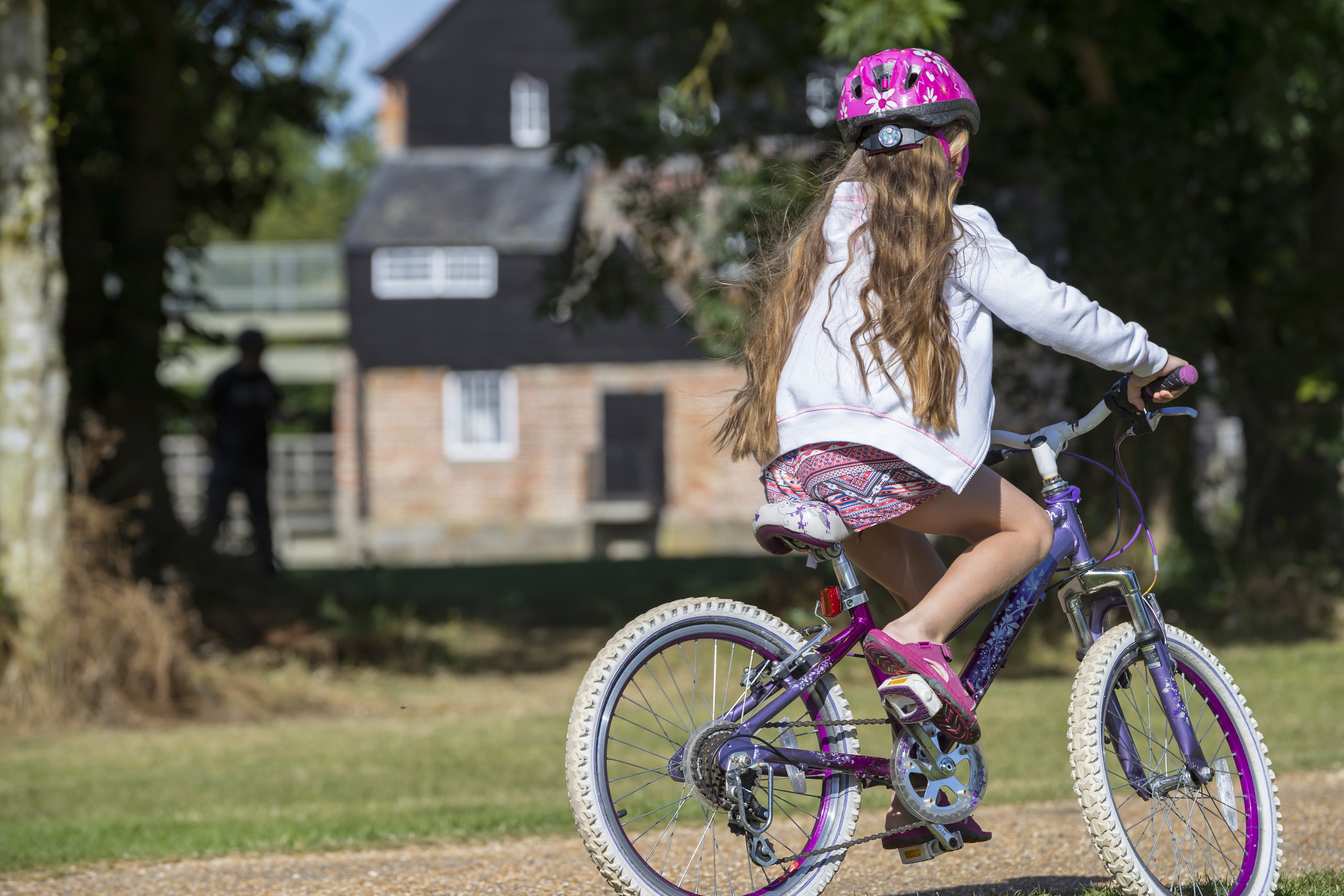 Child on a bike at Houghton Mill and Waterclose Meadows