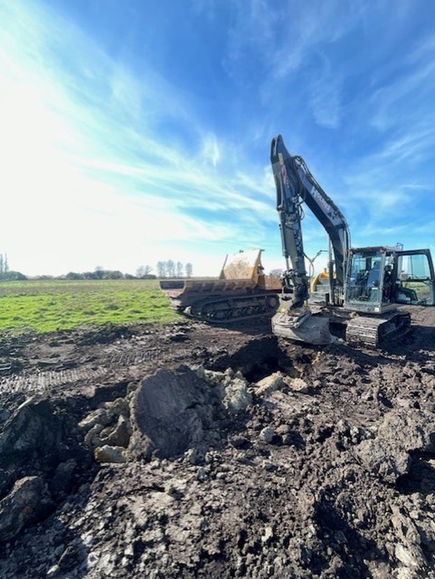 A digger excavating clay