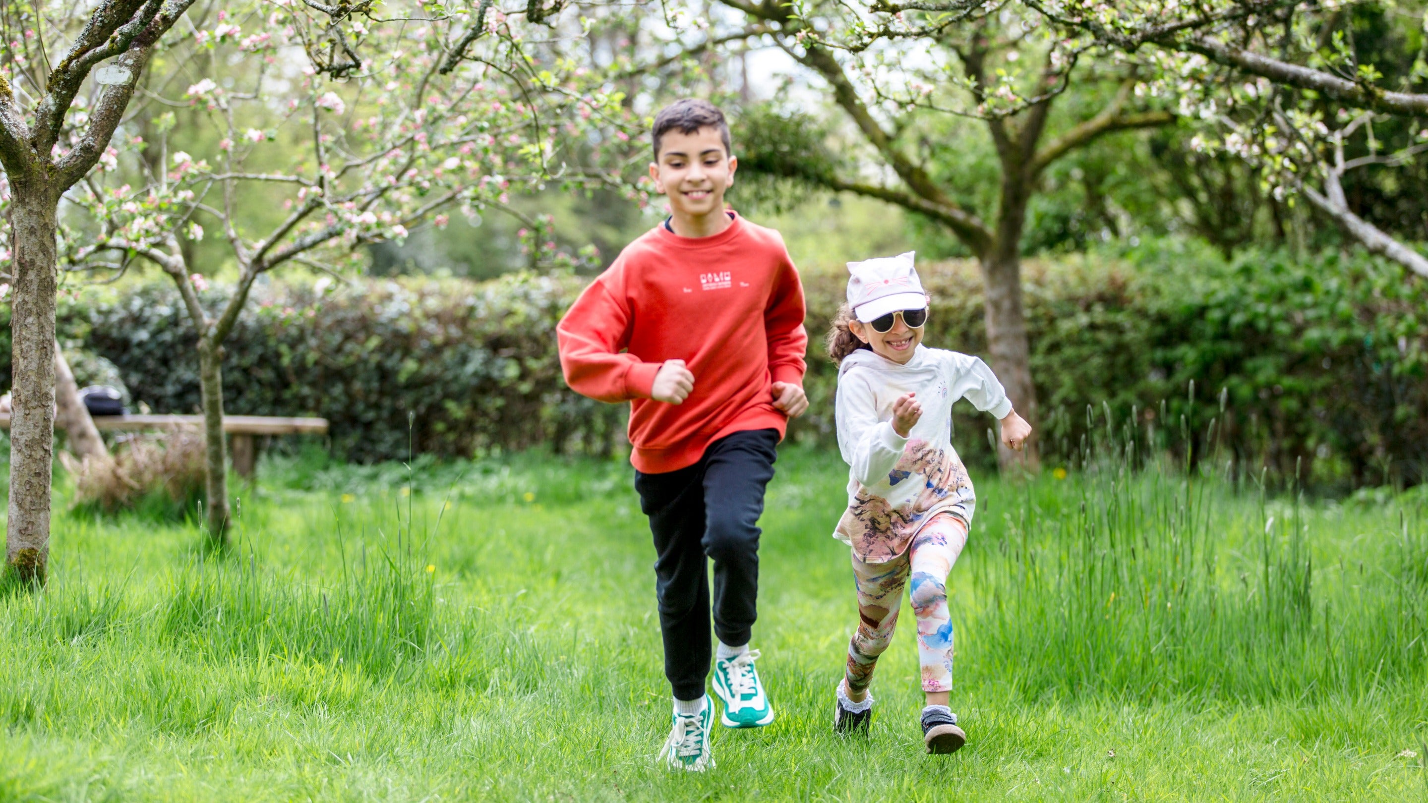 A family in the orchard during the Festival of Blossom at Quarry Bank, Cheshire