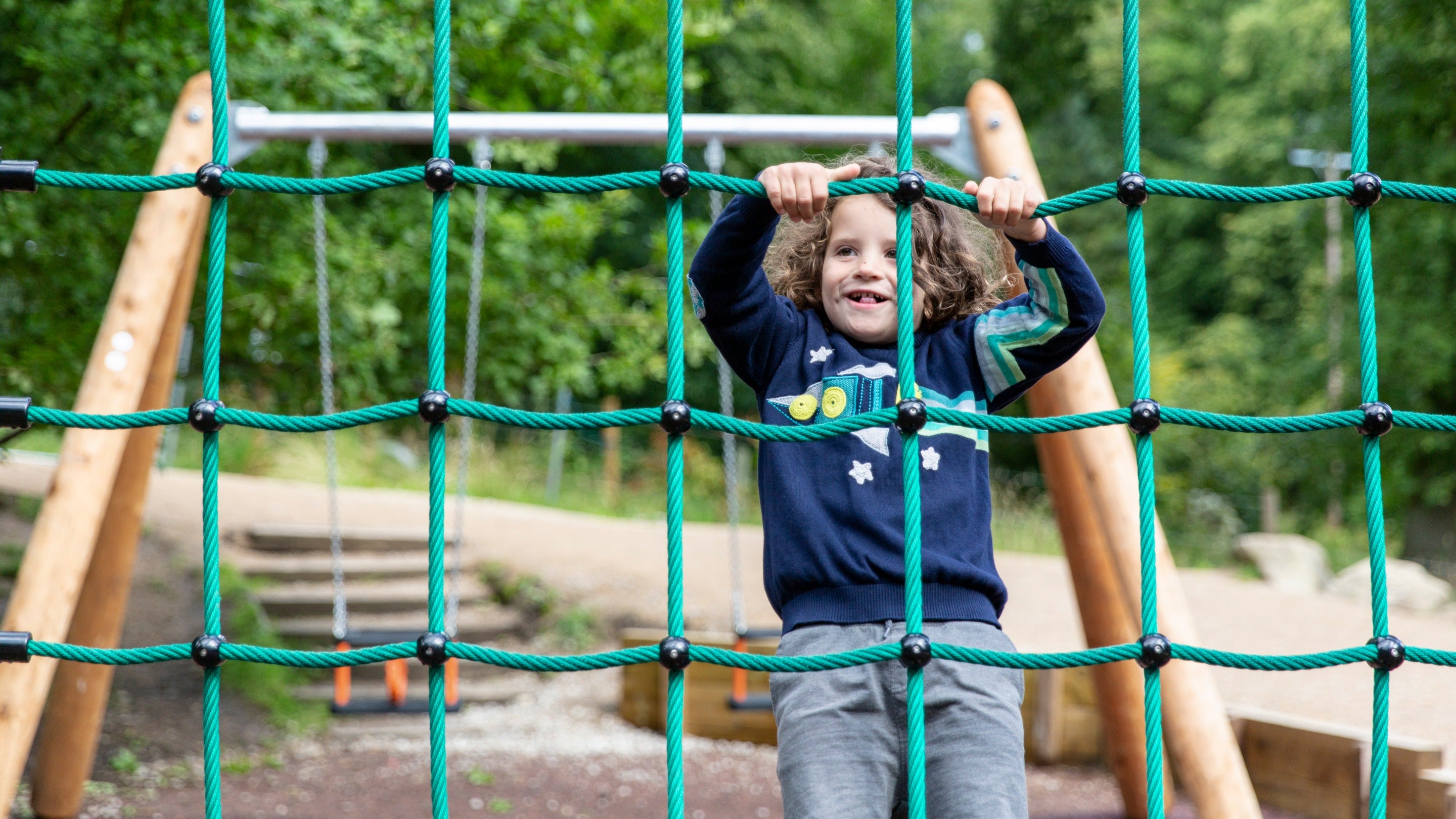 Child enjoying the Crow Wood play area at Lyme Park, Cheshire