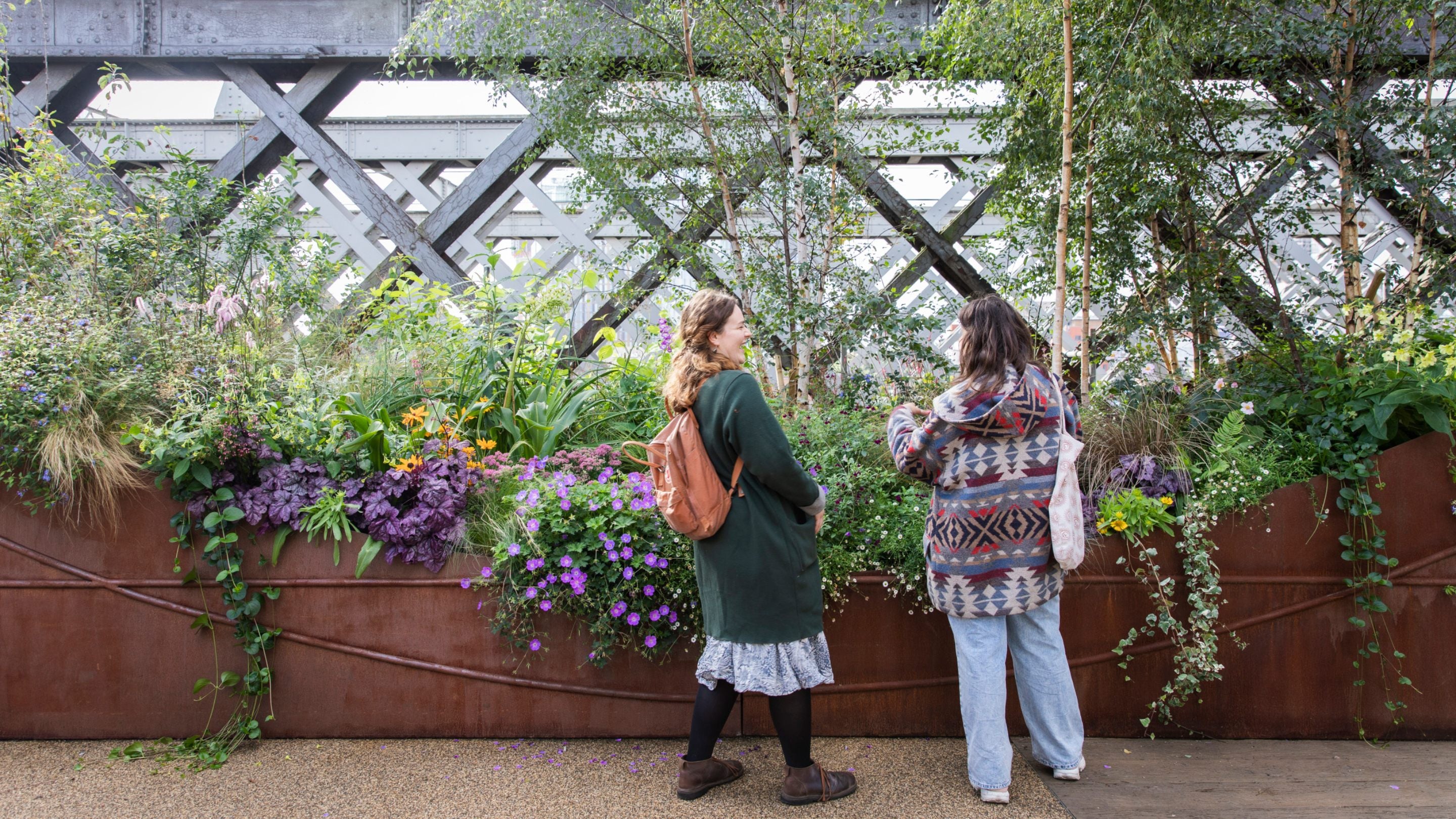 Visitors exploring the urban garden at Castlefield Viaduct, Manchester