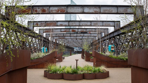 Sections of the metal top of the viaduct with spring blooms in the centre on the path