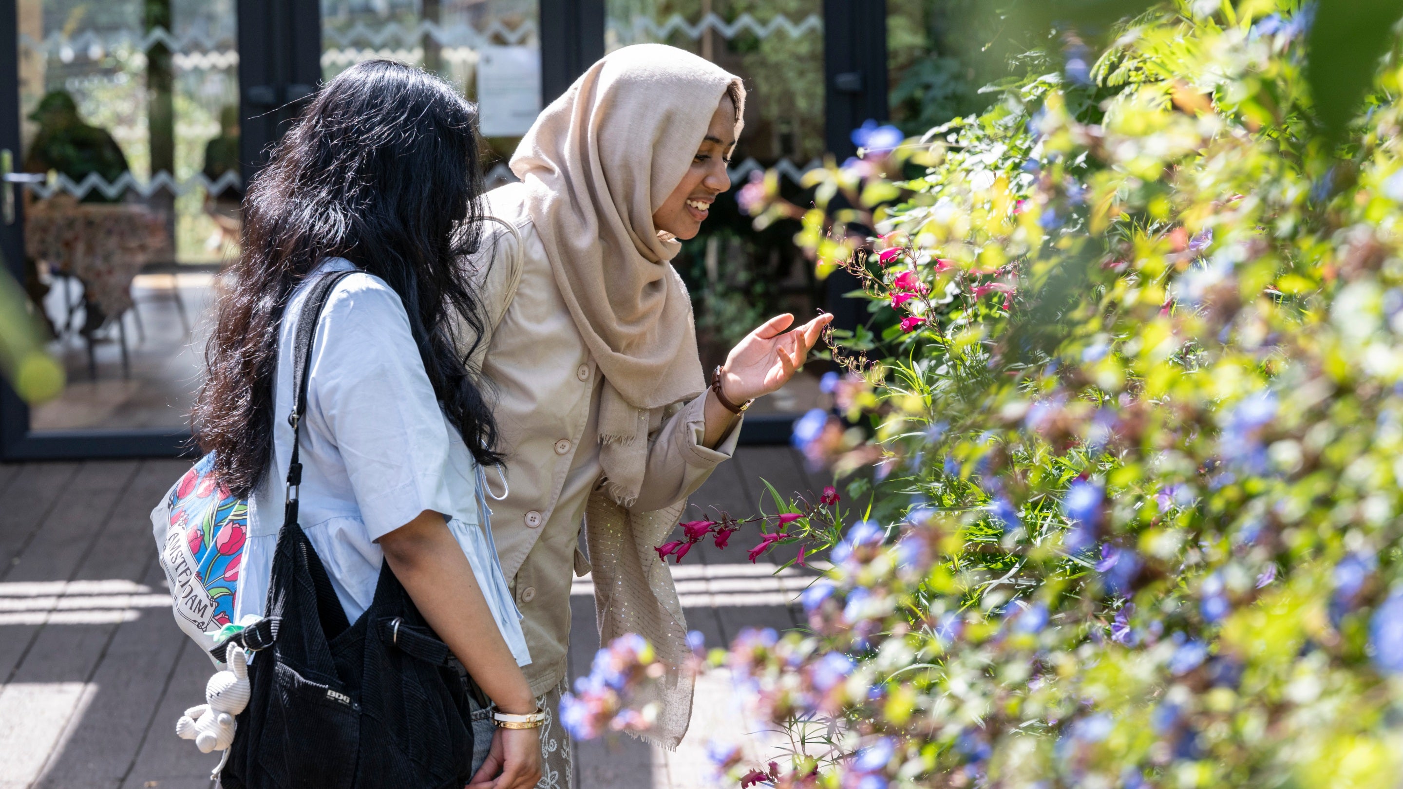 Visitors exploring the summer garden at Castlefield Viaduct, Manchester