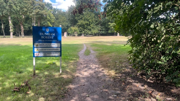 A blue sign, on it is written Dunham Massey Golf Course