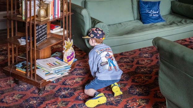 A young visitor looking browsing the book nook in the House