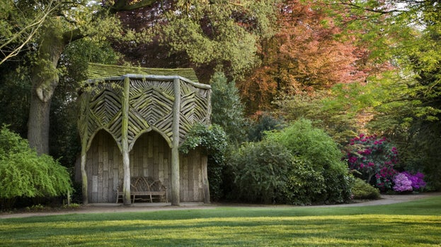 A view of  the Bark House nestled in a vibrant green at Dunham Massey.