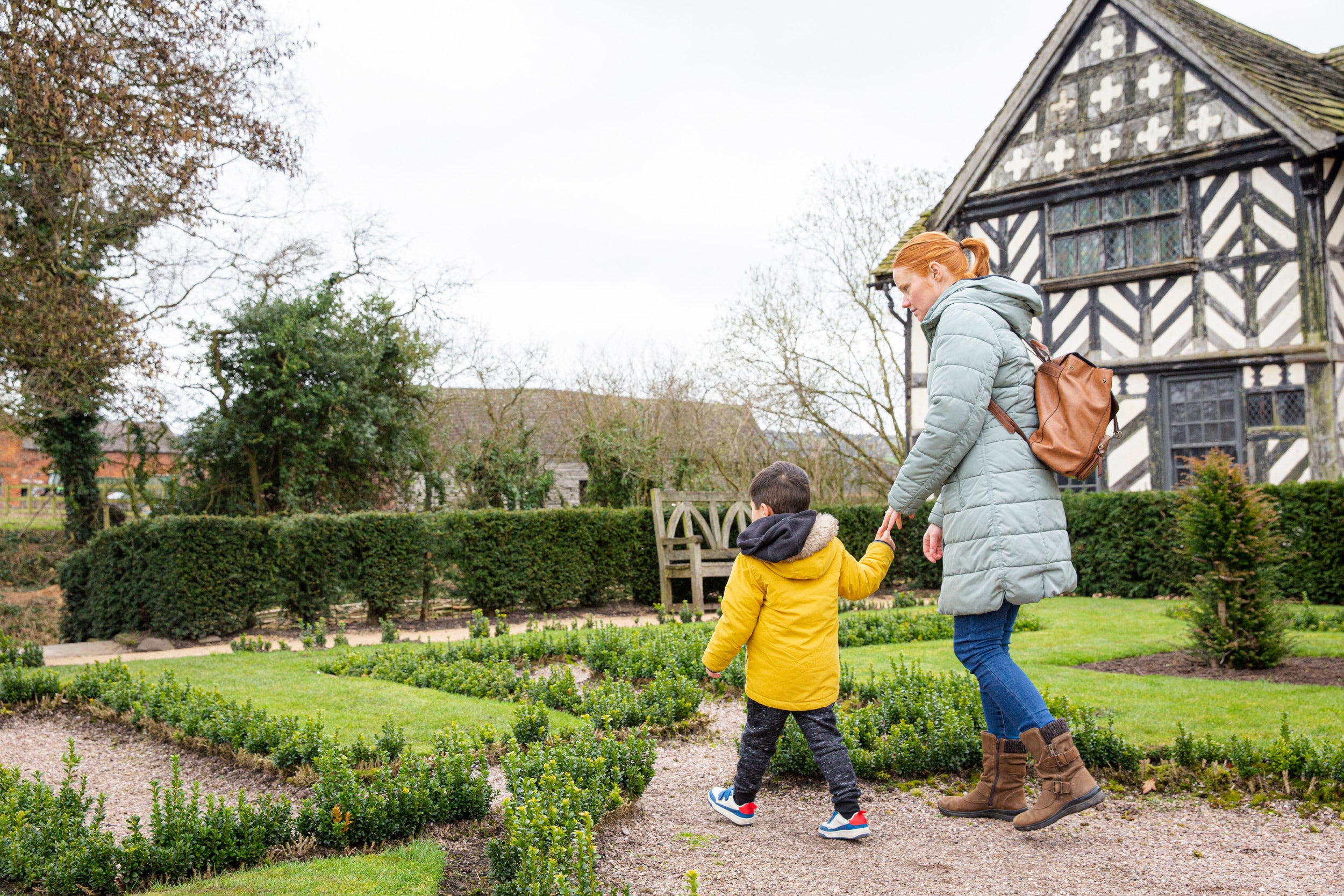 A family enjoying the gardens at Little Moreton Hall, Cheshire