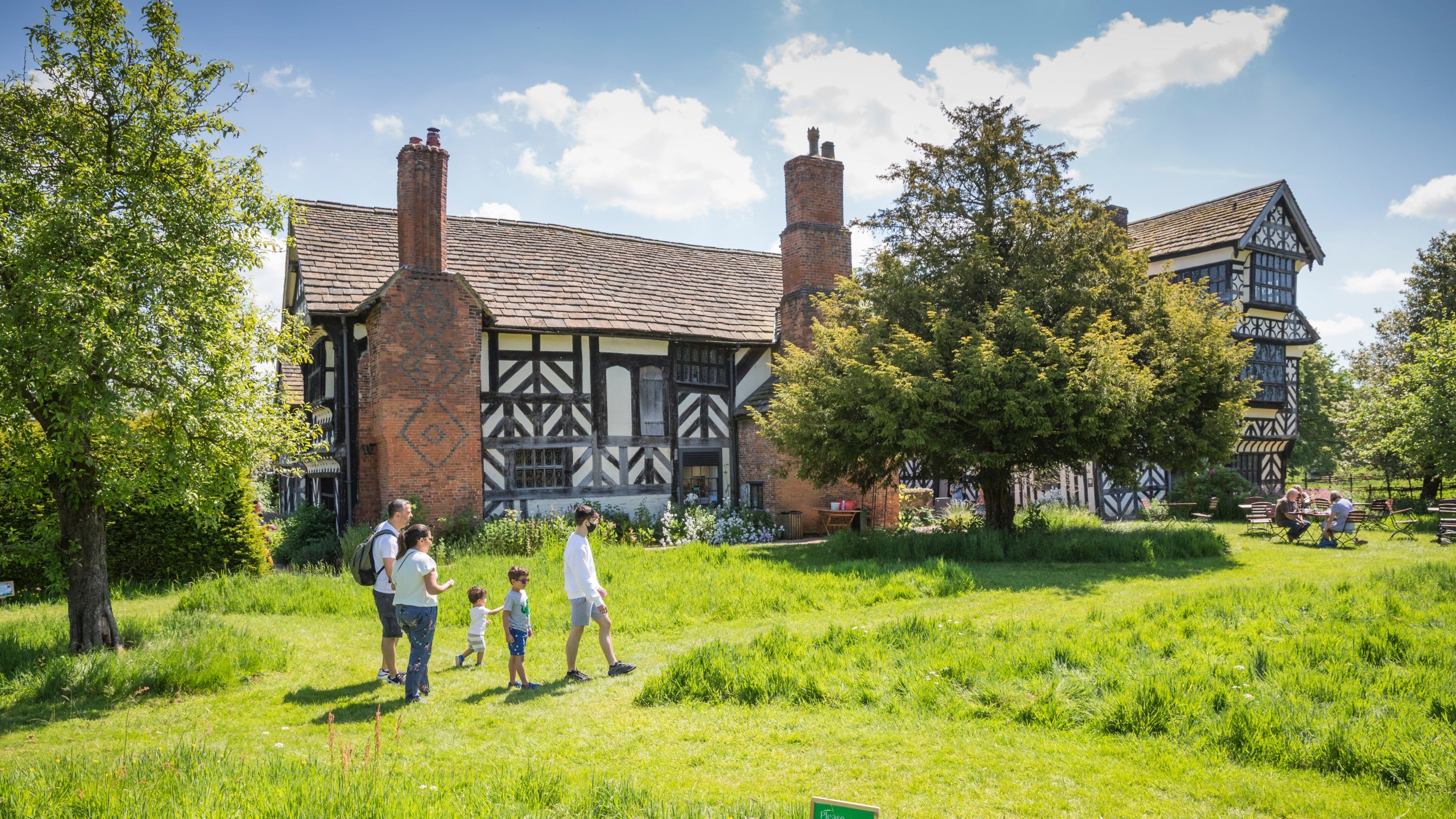 Visitors in the orchard at Little Moreton Hall