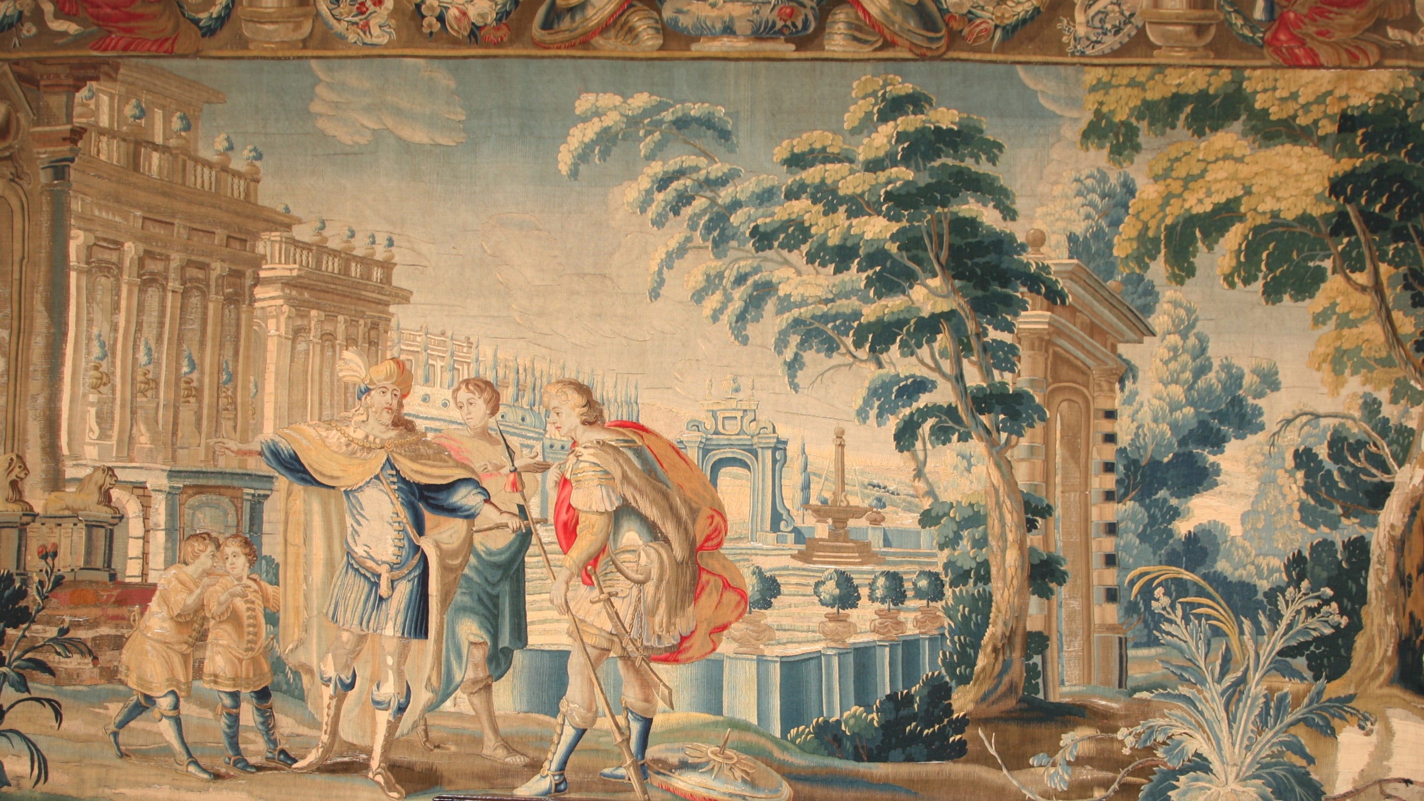 A woven 17th century tapestry that shows three smartly dressed men in front of a columned building.