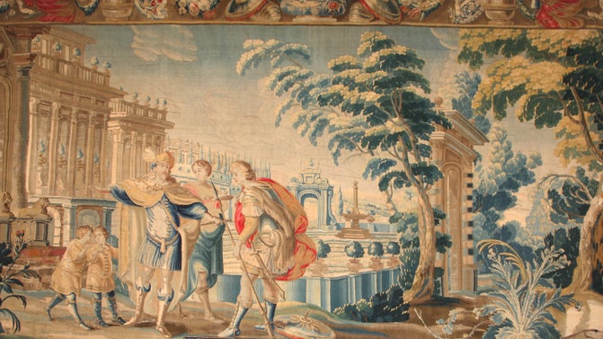 A woven 17th century tapestry that shows three smartly dressed men in front of a columned building.