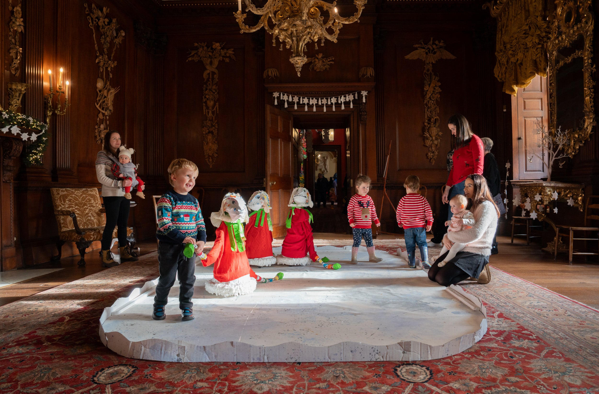 Visitors admire the majestic animal decorations created by artist Sophie Tyrrell in the Saloon at Lyme, Cheshire