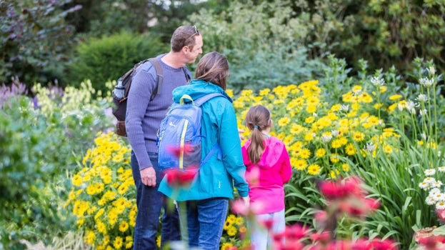 Family exploring the herbaceous border at Lyme Park, Cheshire