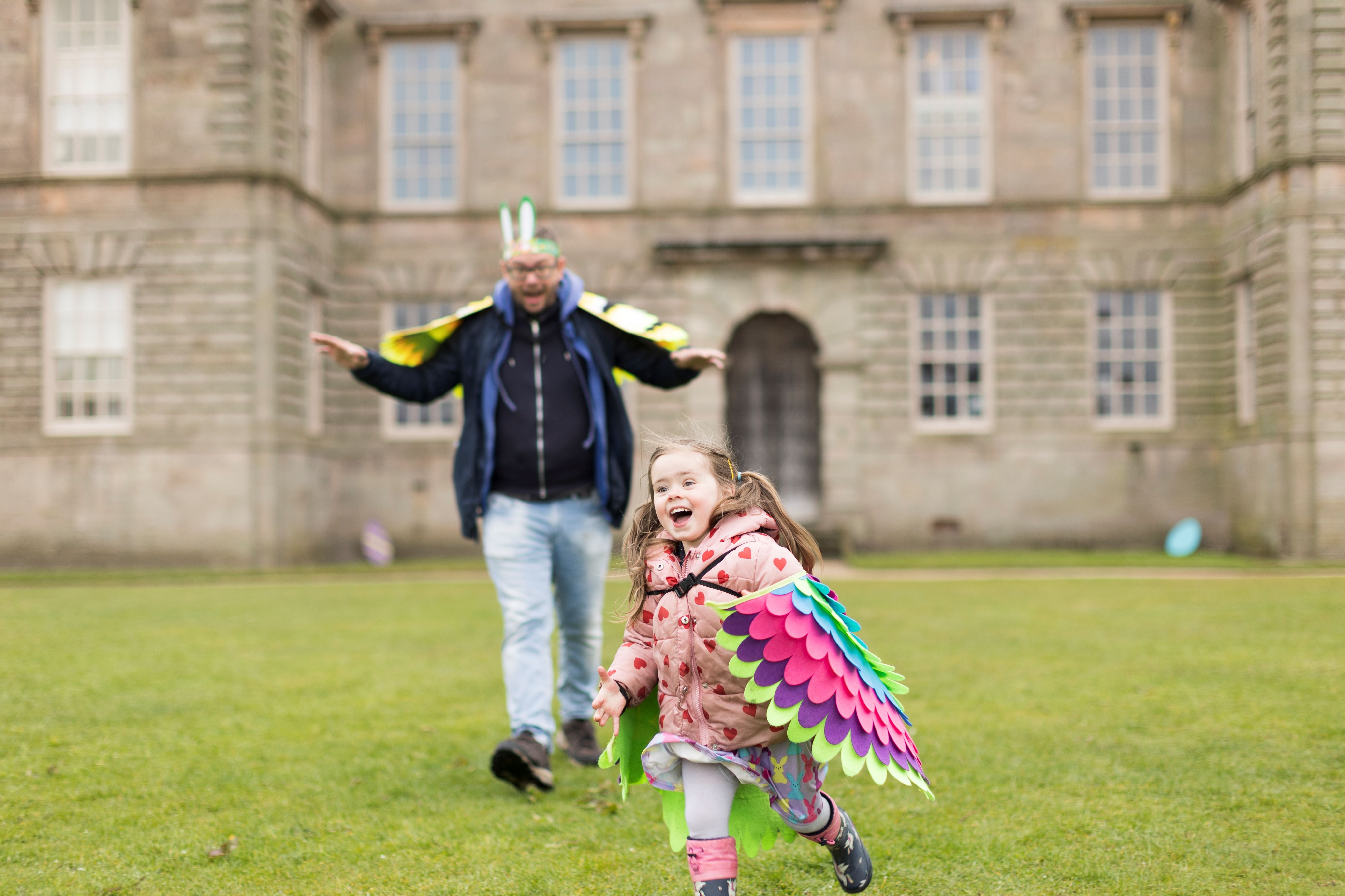 Families exploring the Easter Adventures Trail in the park at Lyme, Cheshire