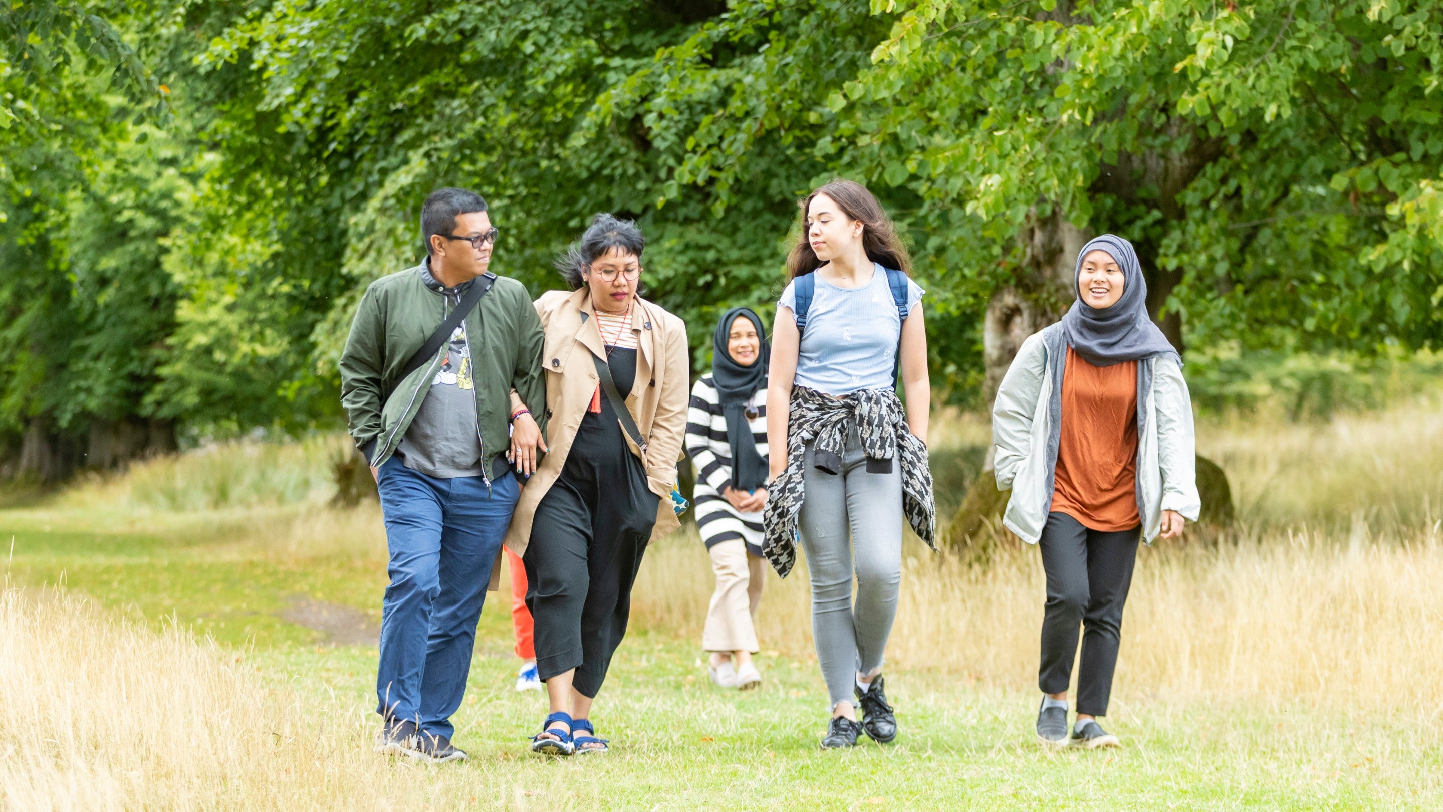 Visitors exploring the extensive parkland at Lyme, Cheshire