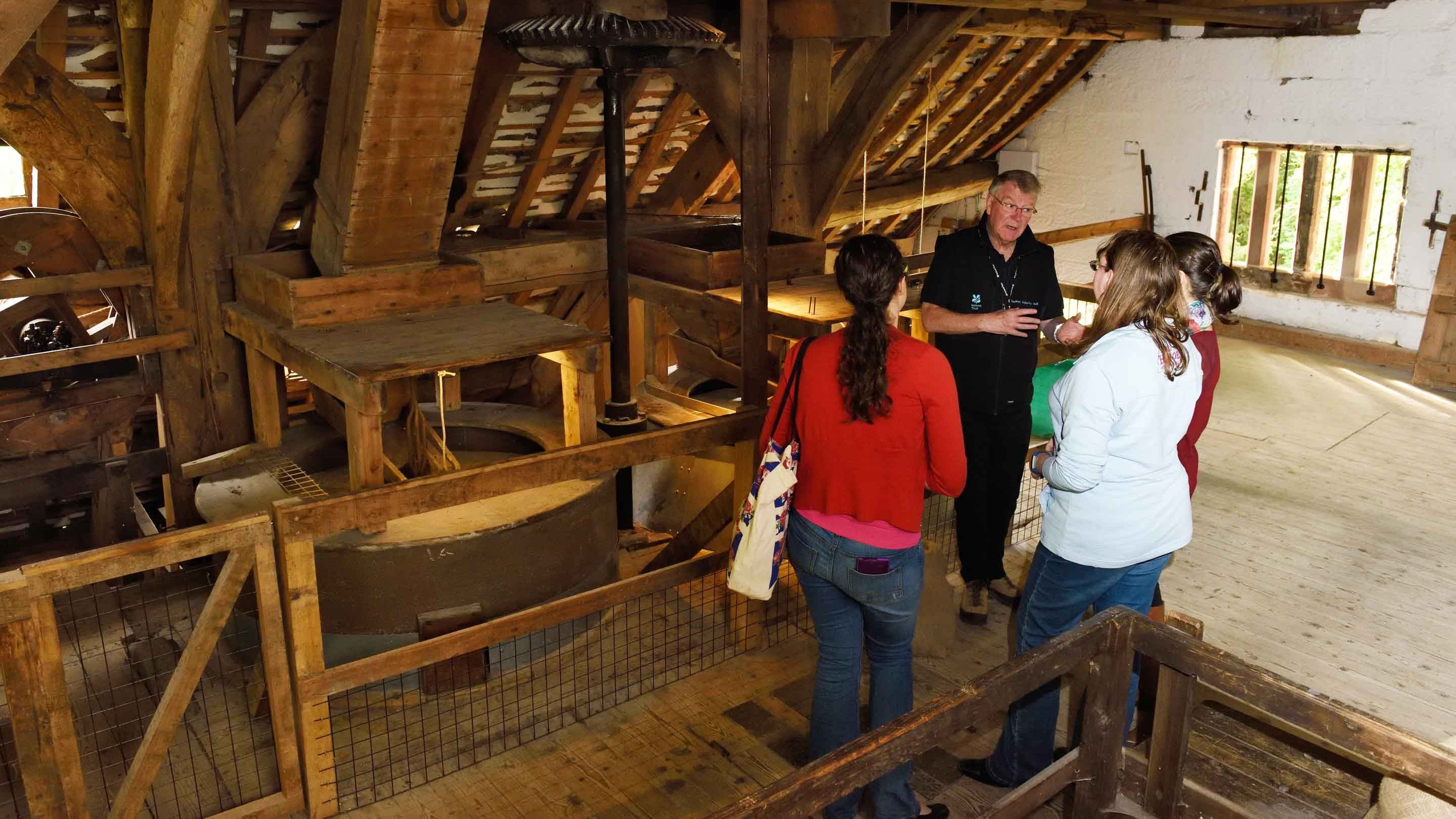 Visitors on a guided tour at Nether Alderley Mill, Cheshire