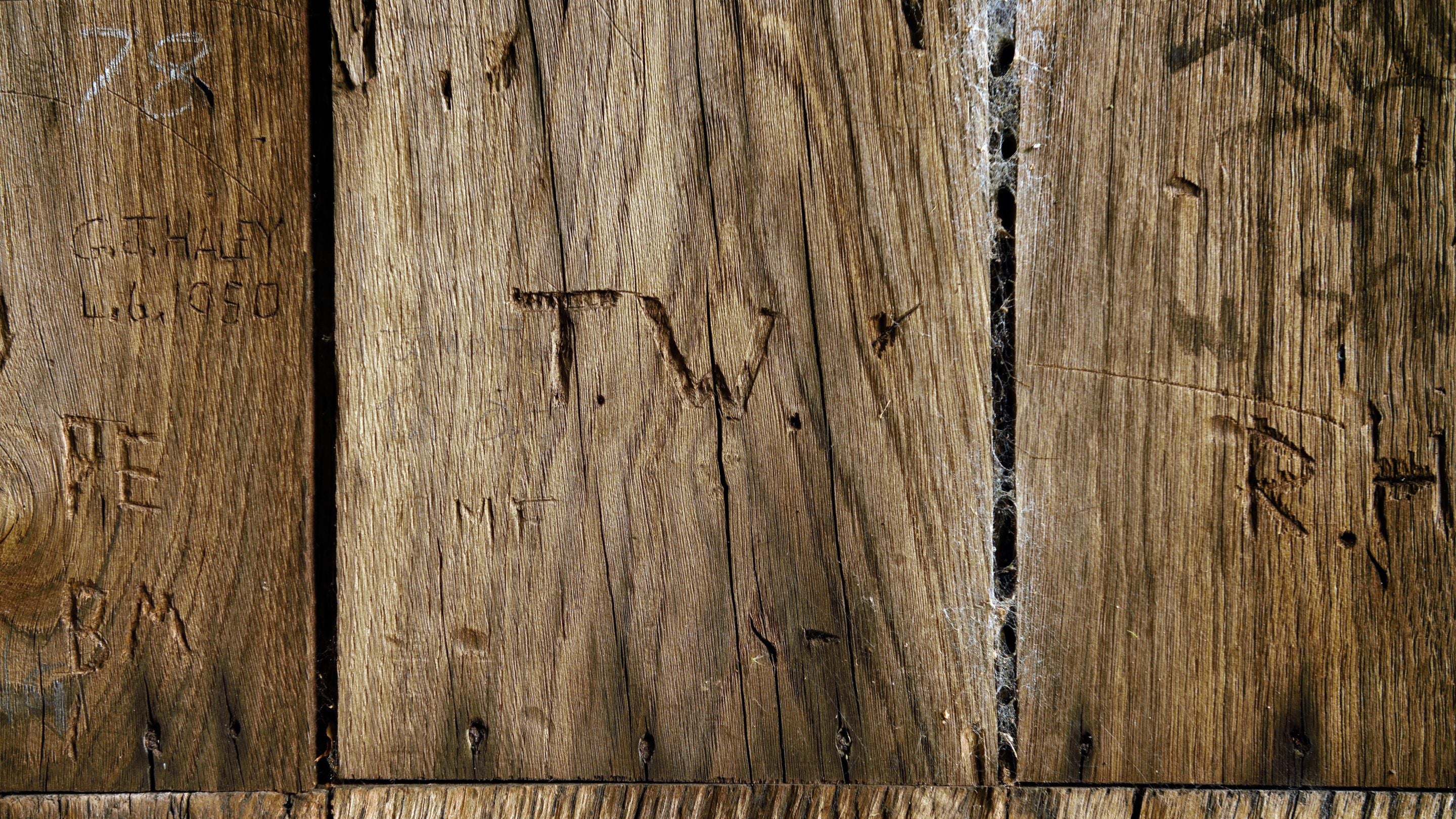 The names of previous millers and workers on the entrance door at the Nether Alderley Mill, Cheshire