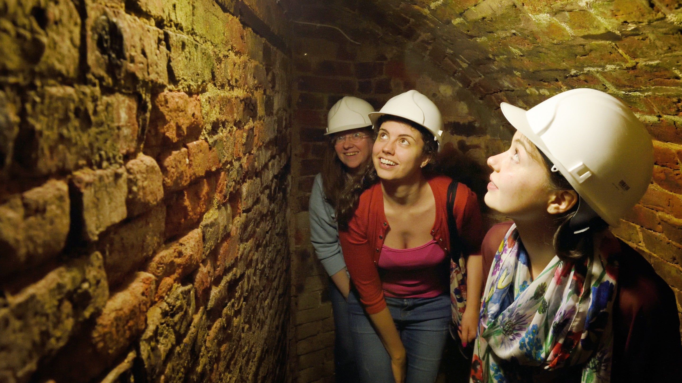 Visitors exploring the kiln during a guided tour at Nether Alderley Mill, Cheshire