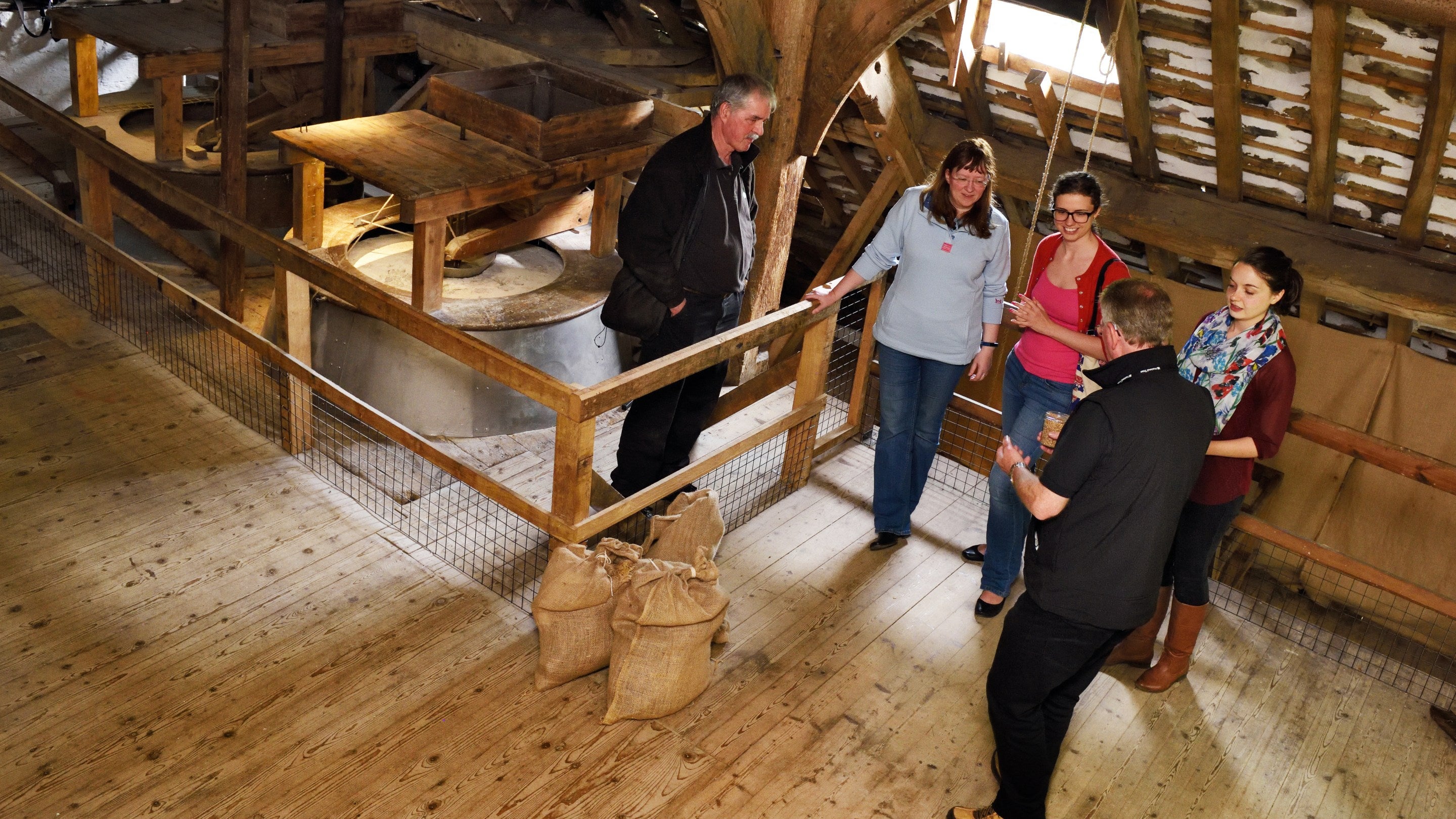 Visitors on a guided tour at Nether Alderley Mill, Cheshire