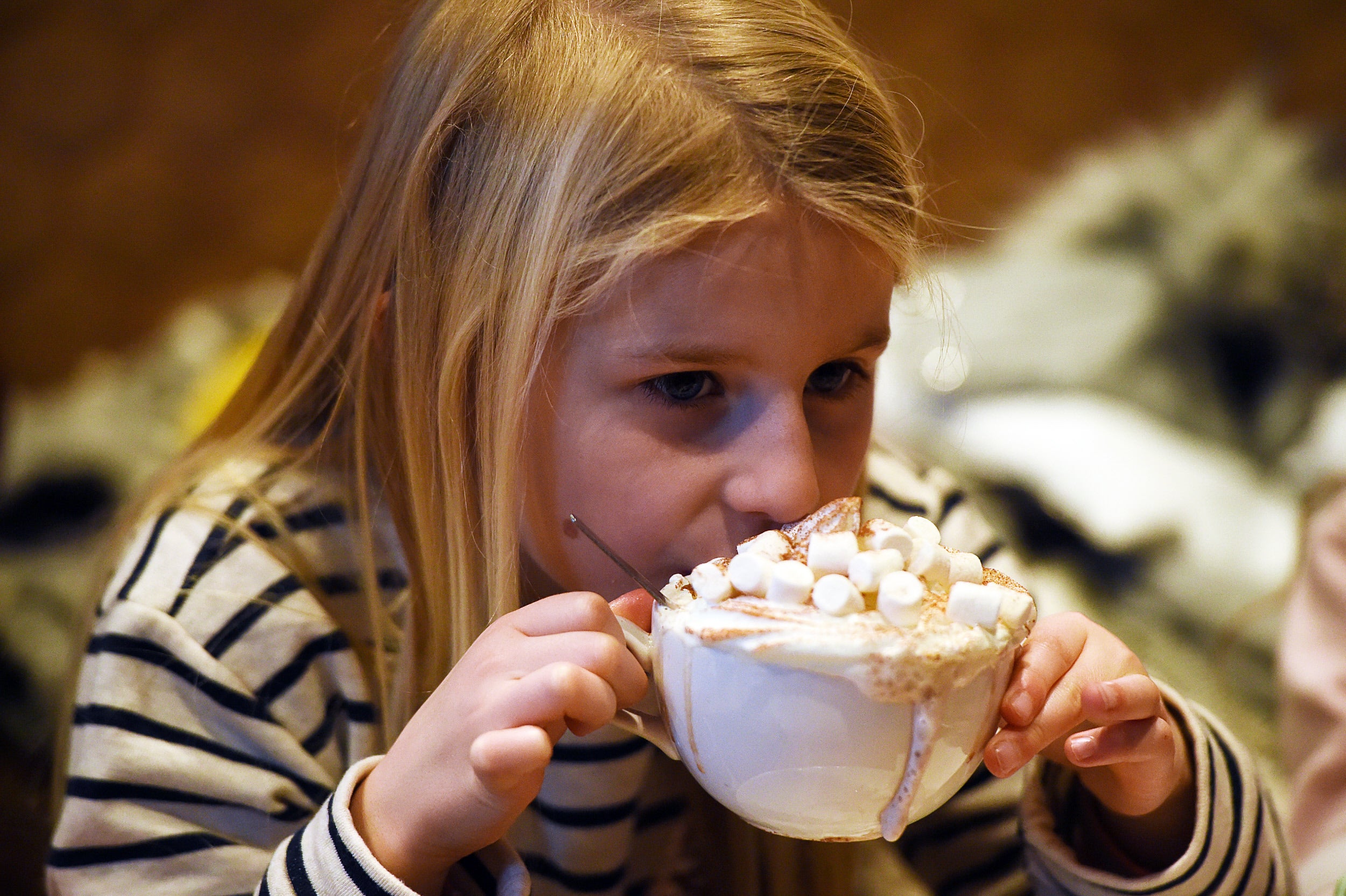 Girl drinking a hot chocolate with marshmallows