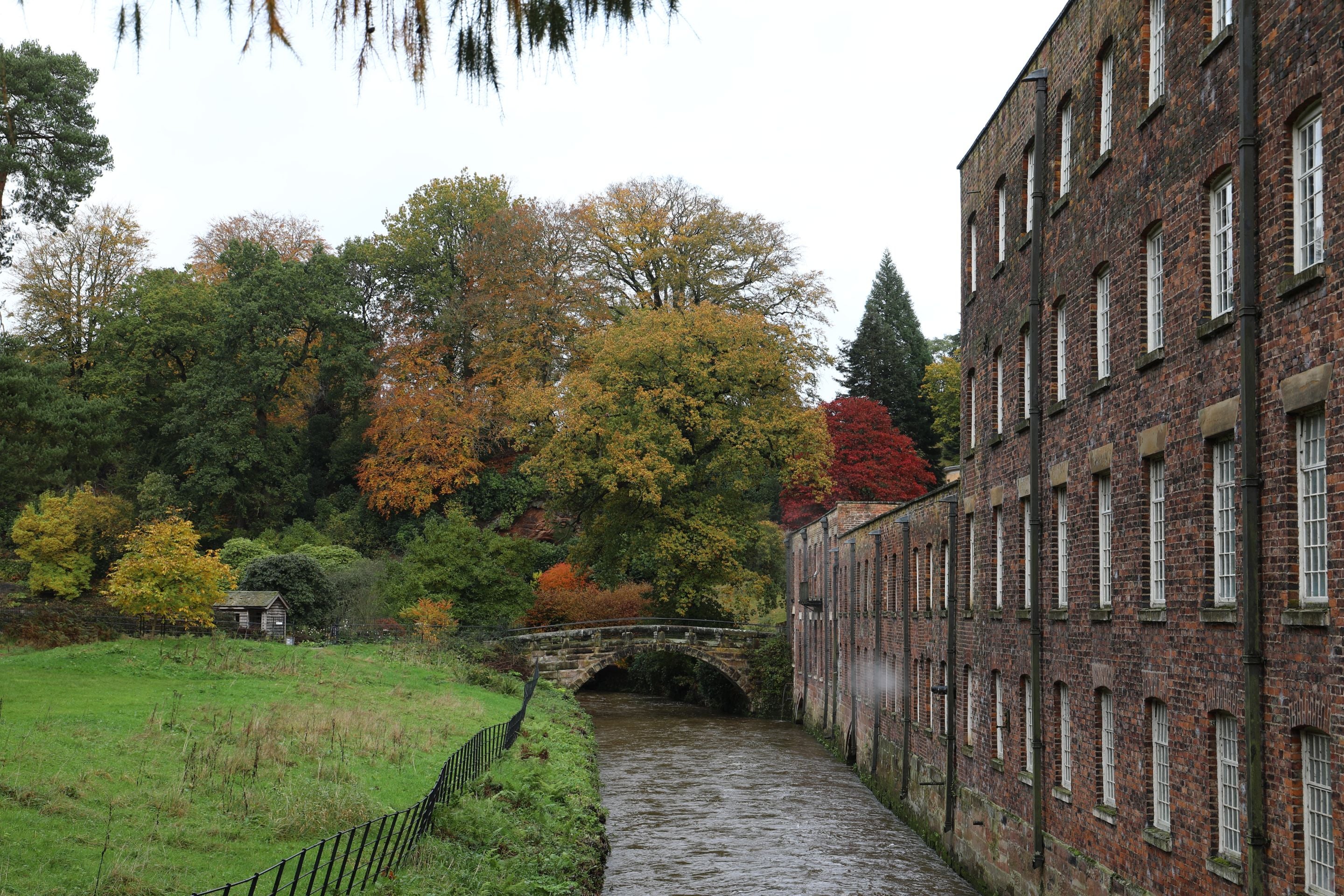 A view of the River Bollin and mill at Quarry Bank in Autumn