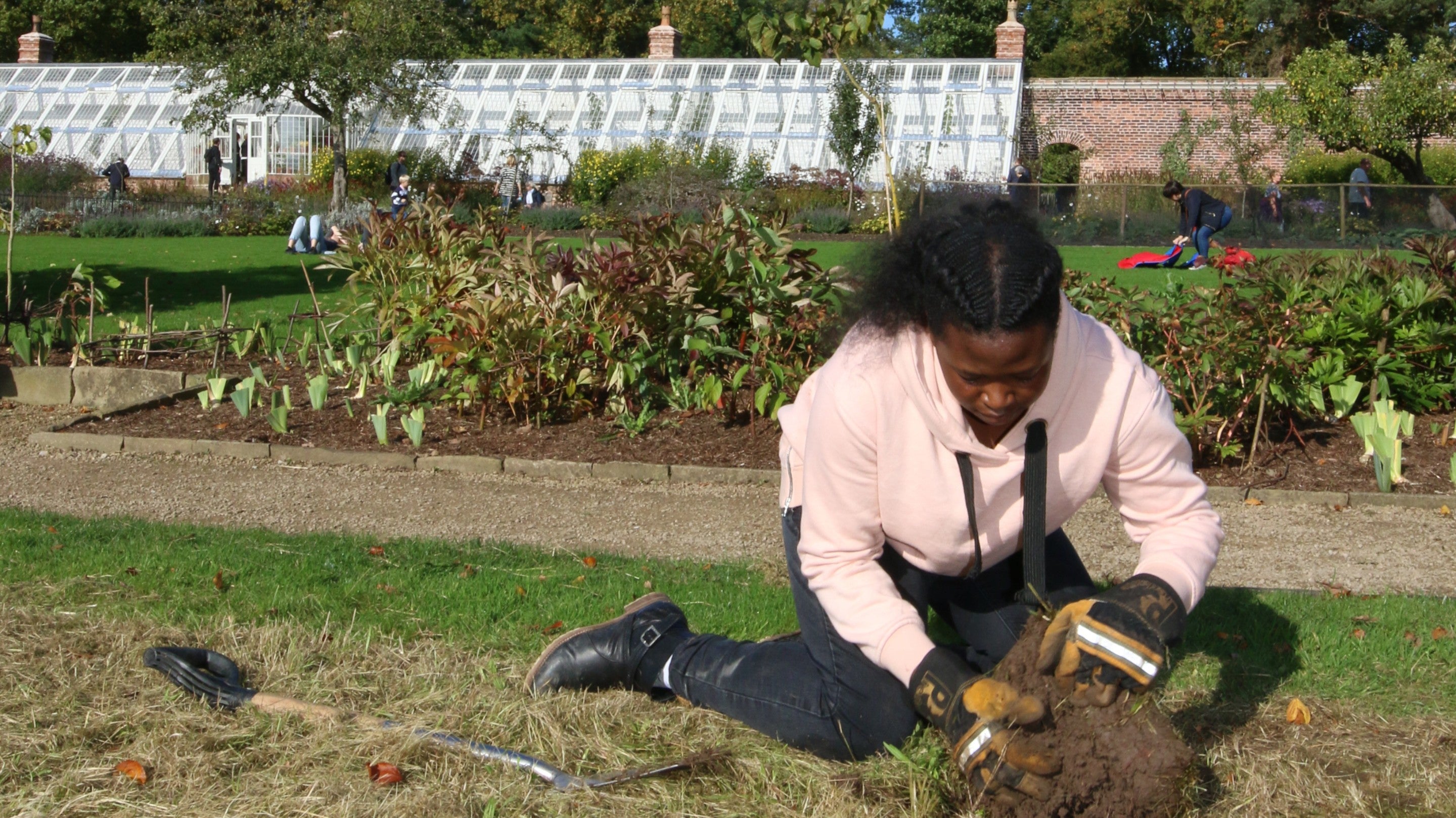 Green academy programme volunteer on a wildflower planting project in the upper garden at Quarry Bank Mill, Cheshire