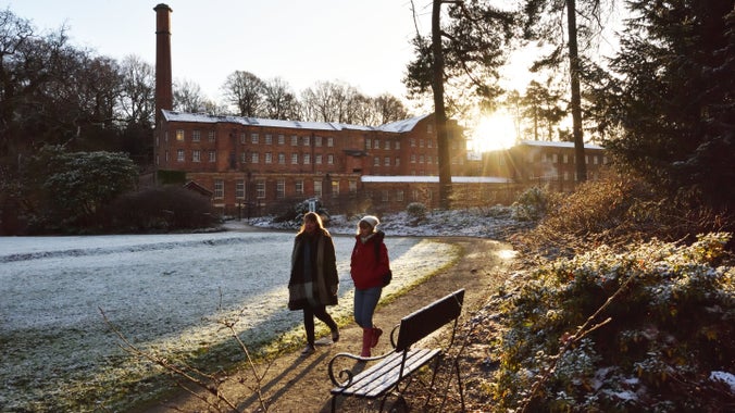 Visitors exploring the garden in winter at Quarry Bank Mill, Cheshire