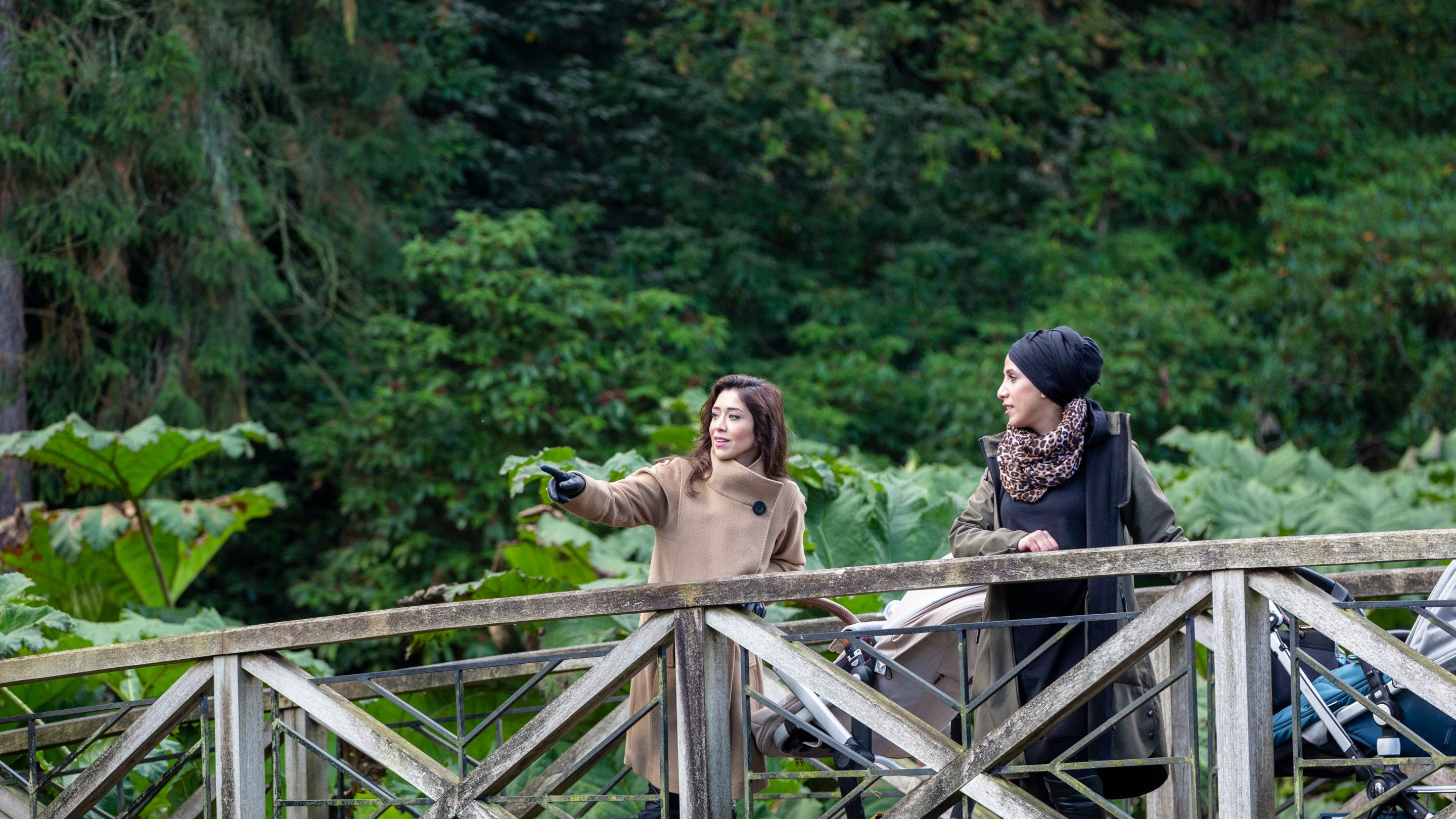 Two visitors exploring the gardens in autumn at Tatton Park, Cheshire