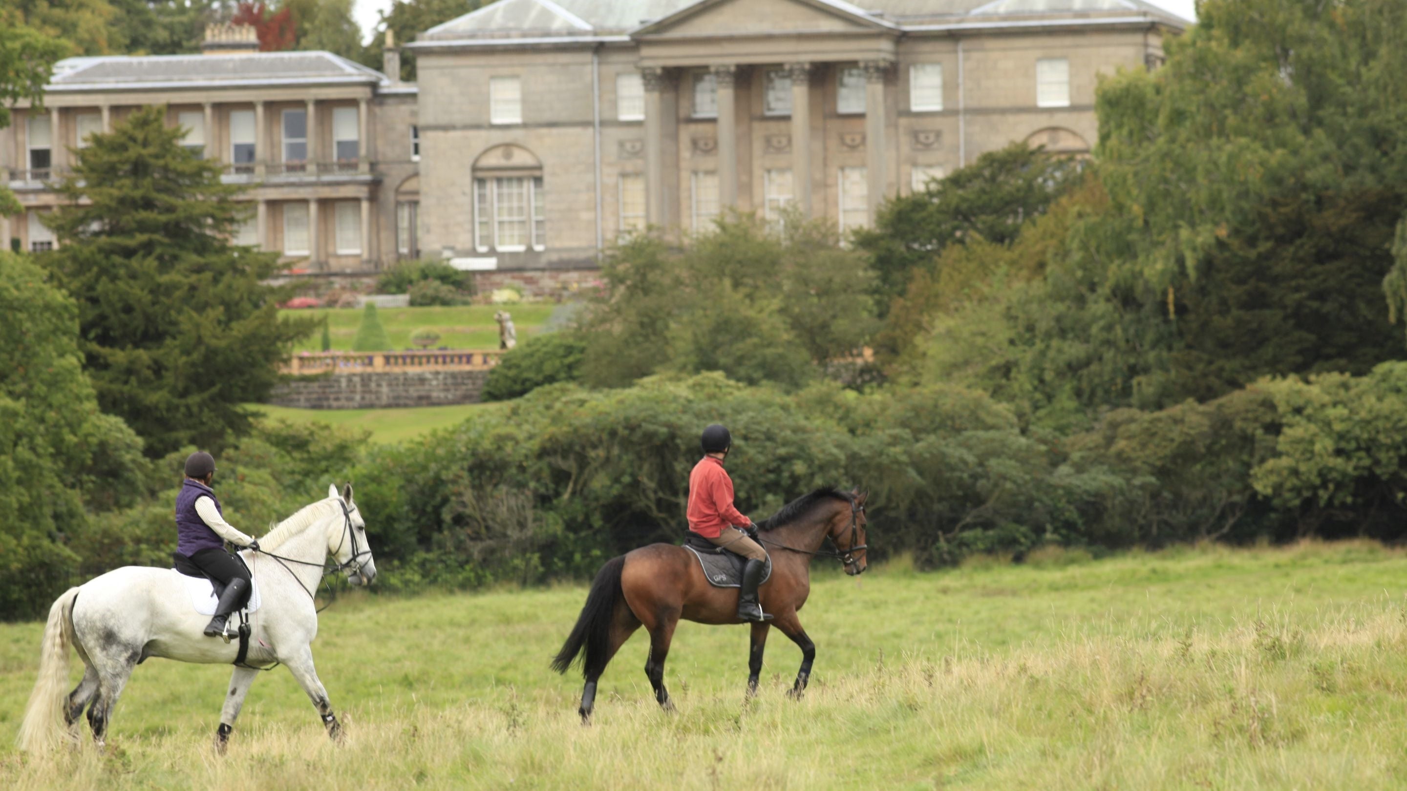 Horseriding through the parkland at Tatton Park, Cheshire