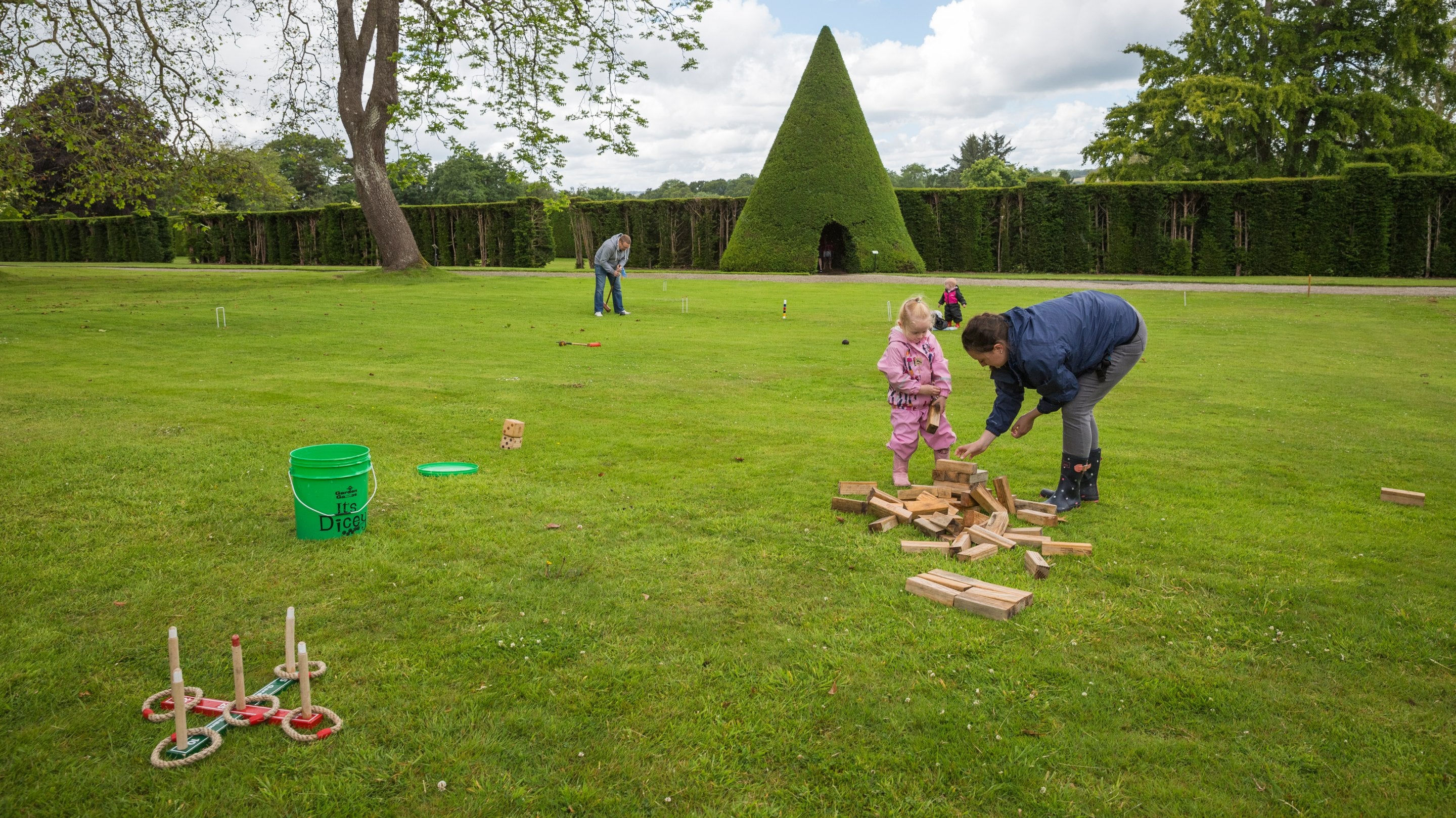 Family playing games in the garden at Antony, Cornwall